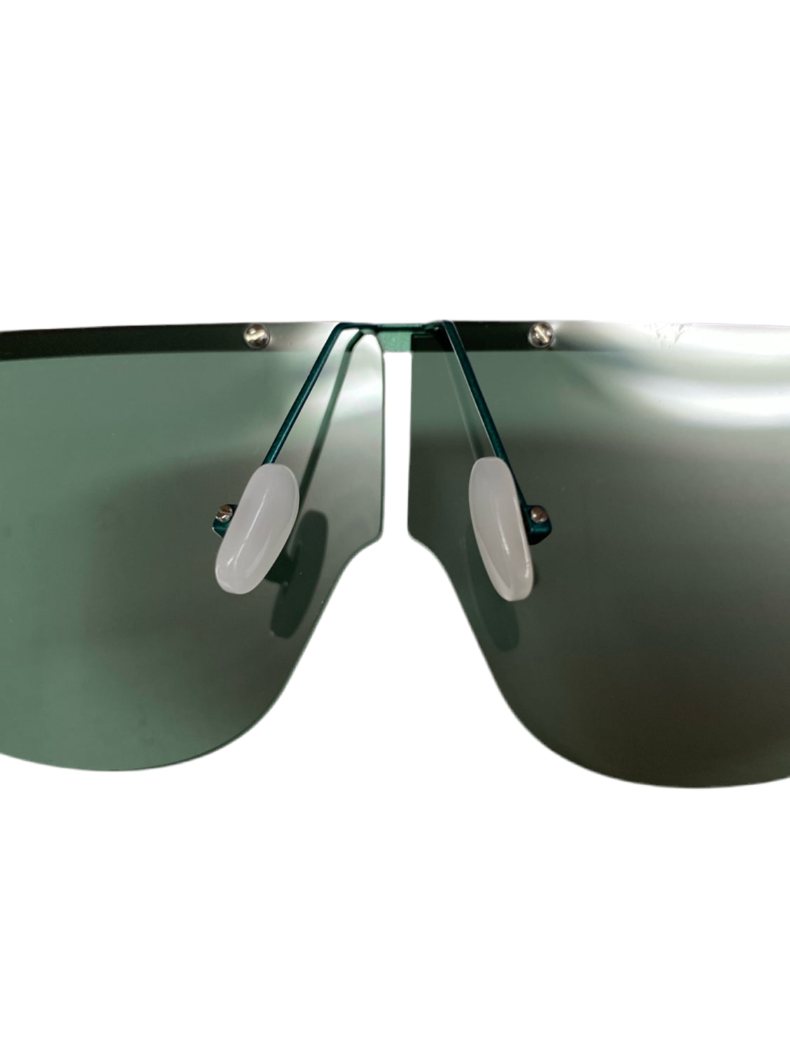 Close-up of a pair of Air sunglasses by For Art&#39;s Sake®, featuring sleek, modern stainless steel frames and UV protected lenses. The single, continuous dark lens and white nose pads create a seamless, futuristic look. The plain white background emphasizes the minimalist design.