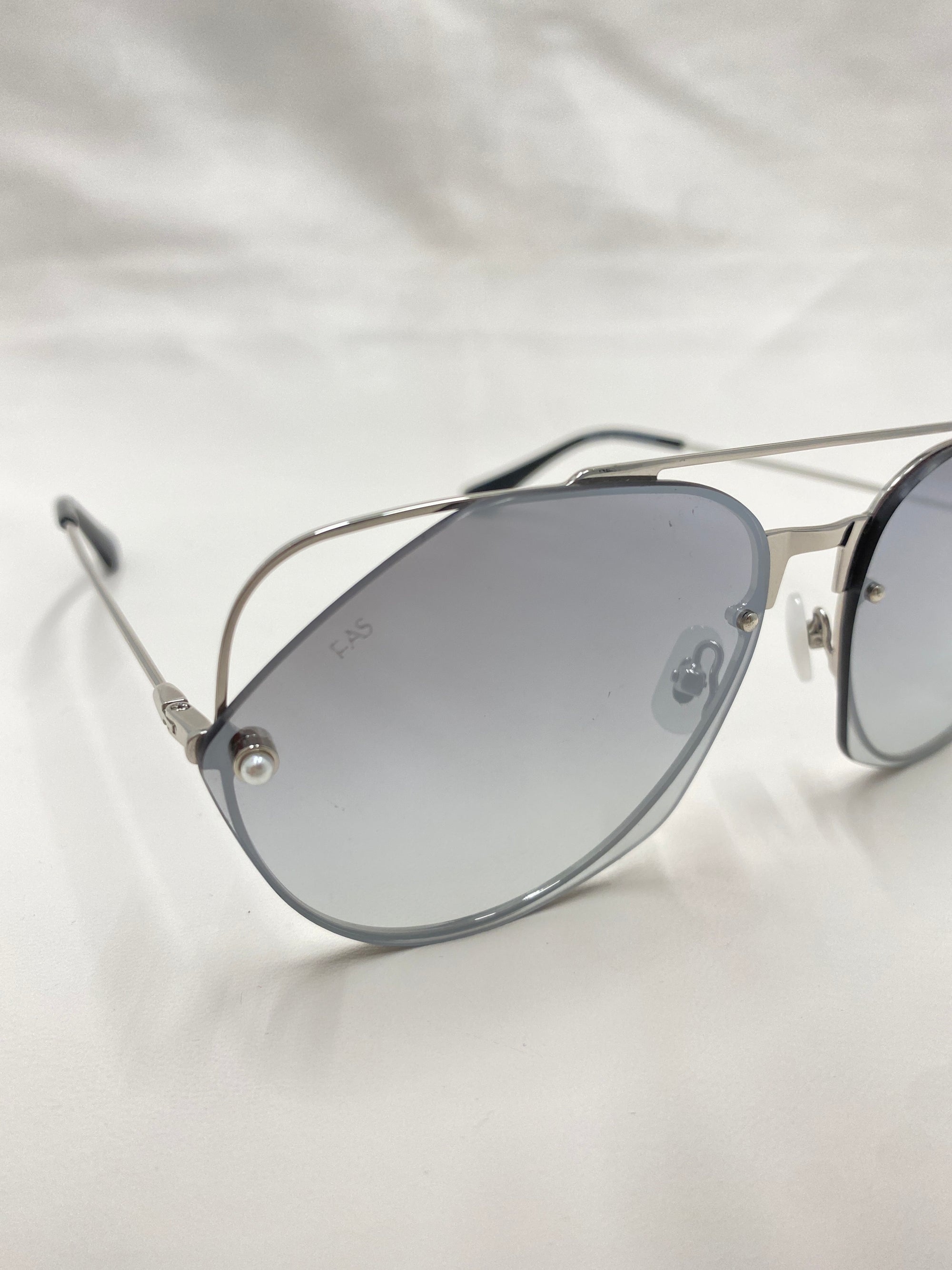 A pair of stylish For Art&#39;s Sake® Casino aviator sunglasses with metallic silver frames, reflective silver lenses, and comfortable jadestone nose pads is positioned against a plain white background.