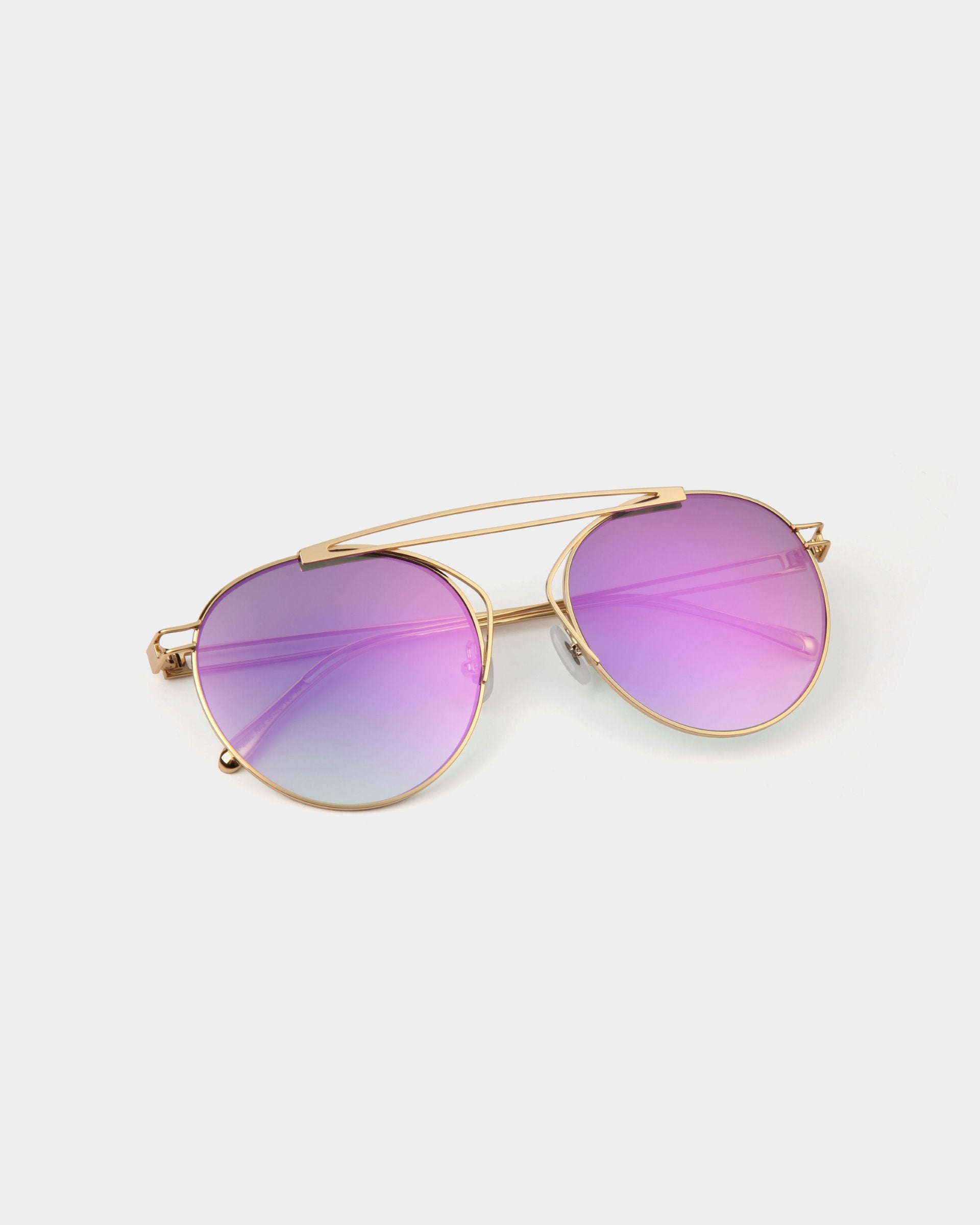 A stylish T-shirt from For Art&#39;s Sake® with round, gradient nylon lenses transitioning from pink at the top to purple and light blue at the bottom. The T-shirt features thin, 18-karat gold-plated frames and a double bridge design.