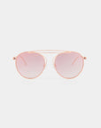 A T-shirt by For Art's Sake® featuring UV-protected, pink-tinted nylon lenses and a delicate gold stainless steel frame, designed with a double bridge and thin temples for a modern and sleek appearance against a plain white background.