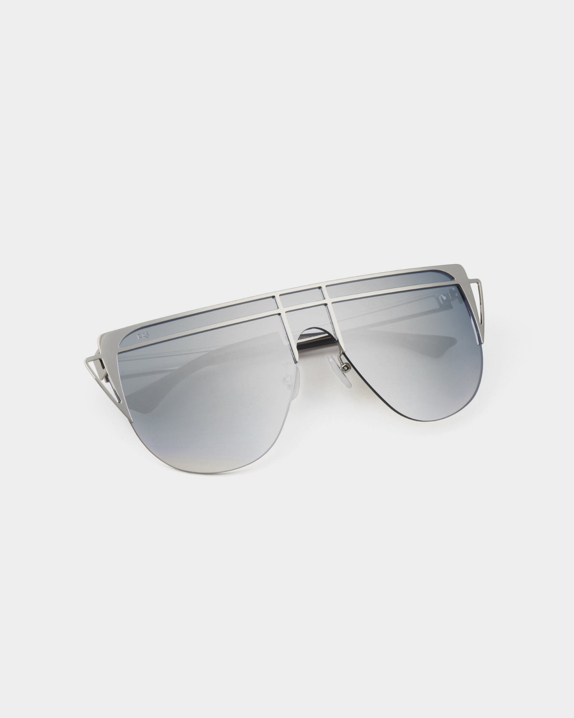 A pair of avant-garde sunglasses, Alien by For Art&#39;s Sake®, with a unique double-bridge design and gradient gray lenses, placed on a white background. The handmade gold-plated stainless steel frames are thin and metallic, giving the sunglasses a sleek and modern appearance while offering 100% UV protection.