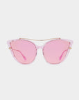 The For Art's Sake® T Two sunglasses feature clear pink acetate cat-eye frames and pink-tinted lenses, shown from the front against a white background. The striking cat-eye design is enhanced by delicate gold accents at the top and on the temples, providing 100% UV protection.