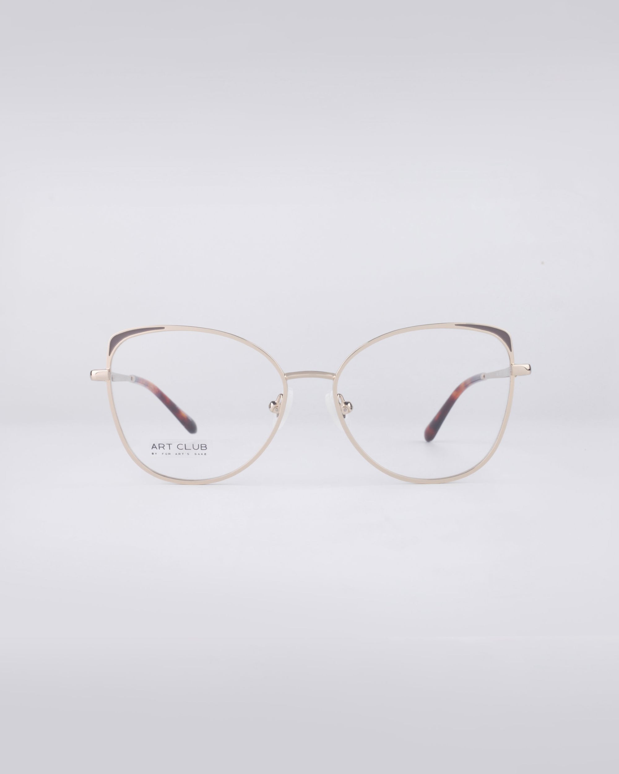 A pair of For Art's Sake® Ada eyeglasses, showcasing gold rims and clear lenses with a stainless steel core, elegantly displayed against a plain white background.