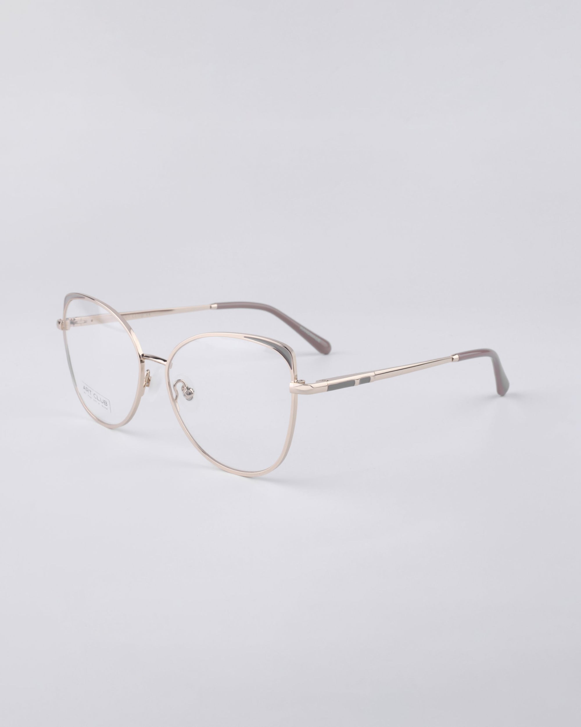 A pair of Ada eyeglasses from For Art's Sake® is set against a plain white background, showcasing their sleek and minimalist wireframe design. These frames feature thin metal arms with a stainless steel core and a subtle nose bridge.