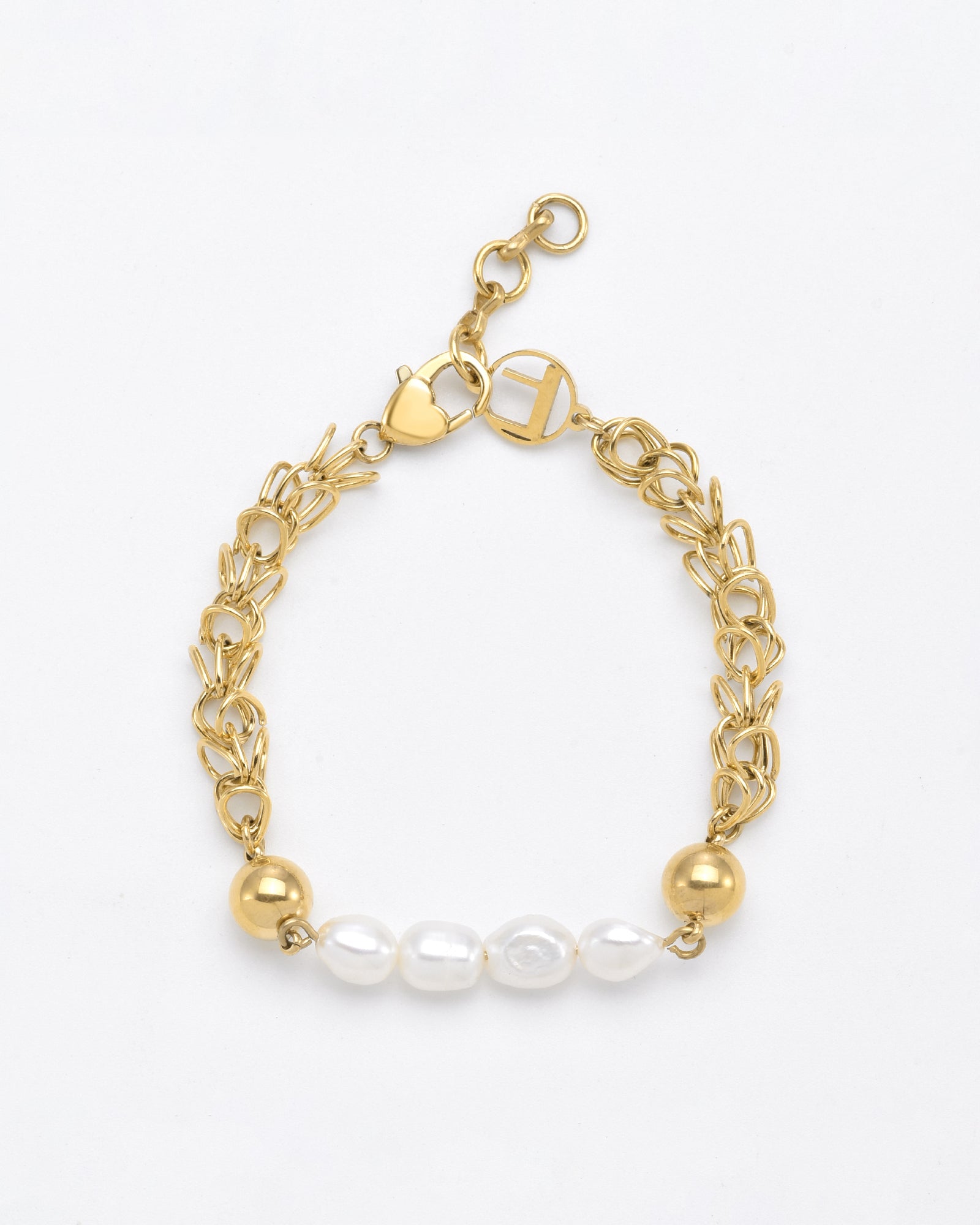 The For Art&#39;s Sake® Athena Bracelet Gold showcases refined elegance with its gold chain featuring a mix of intricate and bold link designs. Adorned with two gold beads and five freshwater pearls at the center, it has a lobster clasp and a small, heart-shaped charm near the clasp for added detail.