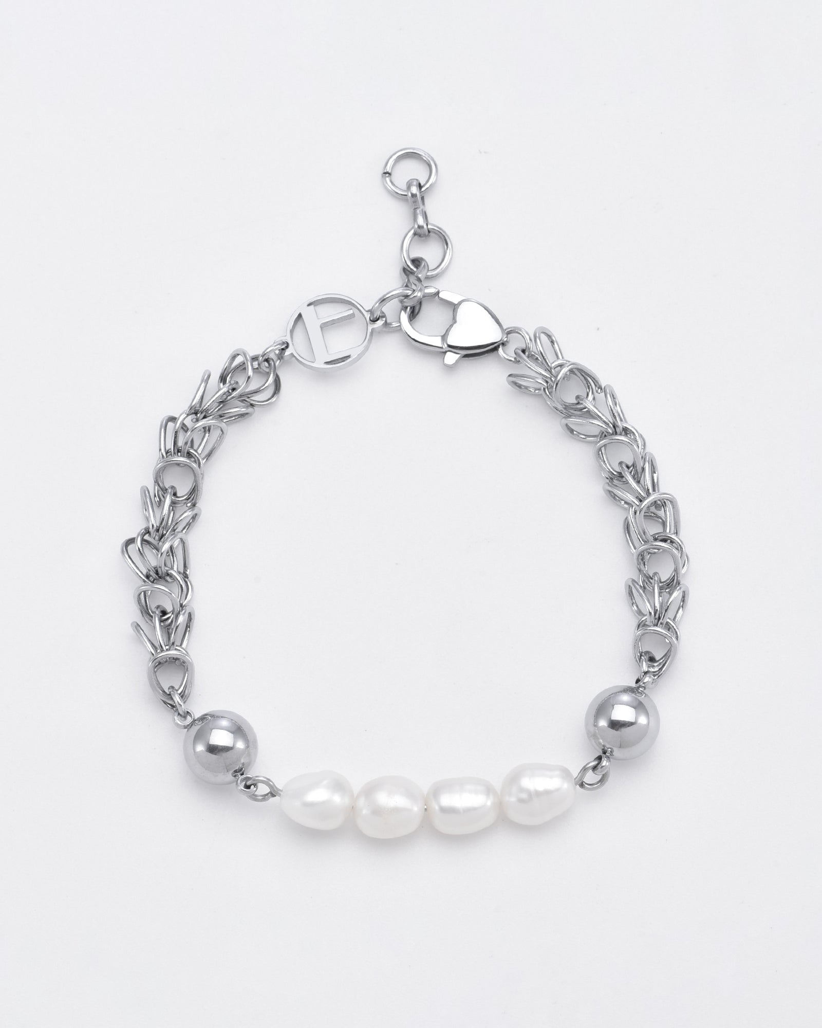 The For Art's Sake® Athena Bracelet Silver exudes refined elegance with a chain of interlinked hearts and a clasp adorned with a heart-shaped lock. At its center, the bracelet showcases five freshwater pearls and one silver bead at each end, offering an elegant contrast to the metallic chain.