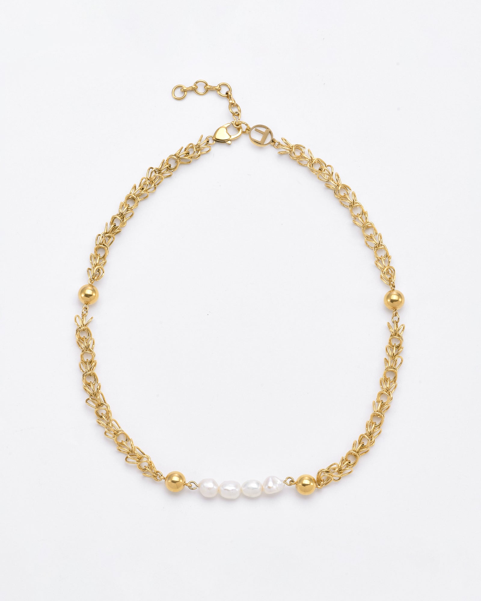 The For Art's Sake® Athena Necklace Gold is a delicate gold chain with an intricate leaf-like design, featuring alternating 24-karat gold plated beads and freshwater pearls at the center. It has an adjustable clasp closure against a plain white background.