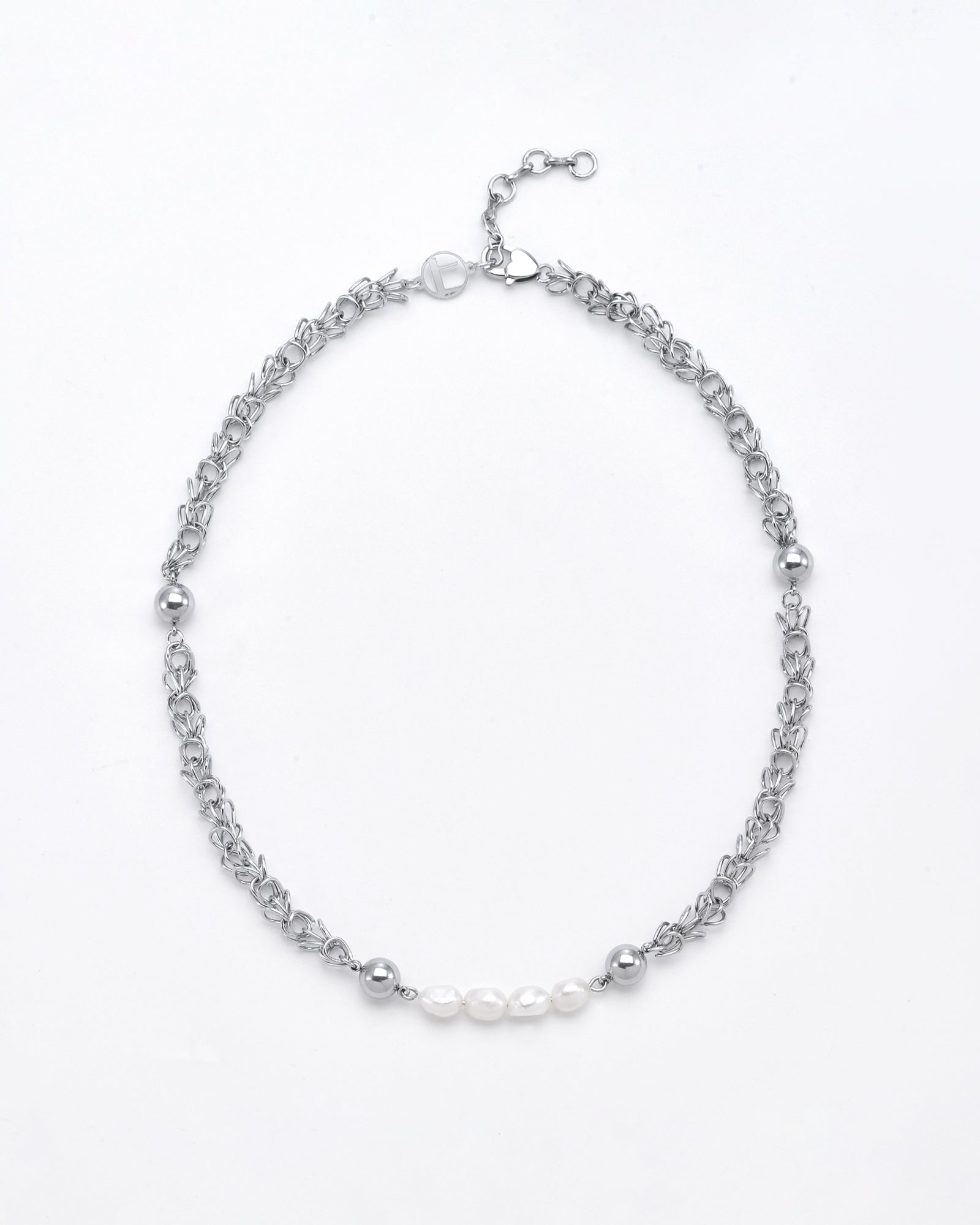 A delicate Athena Necklace Silver by For Art's Sake® with an intricate chain design, featuring three small freshwater pearls and several silver beads spaced symmetrically along the chain. This elegant choker includes an adjustable clasp against a plain, light grey background.