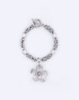 Introducing the "Blossom Bracelet" by For Art's Sake®, a stunning silver chain bracelet featuring a toggle clasp and a prominent flower charm. This elegant piece measures 20.5cm in length, with the flower displaying five intricately detailed petals, beautifully highlighted against a plain white background.