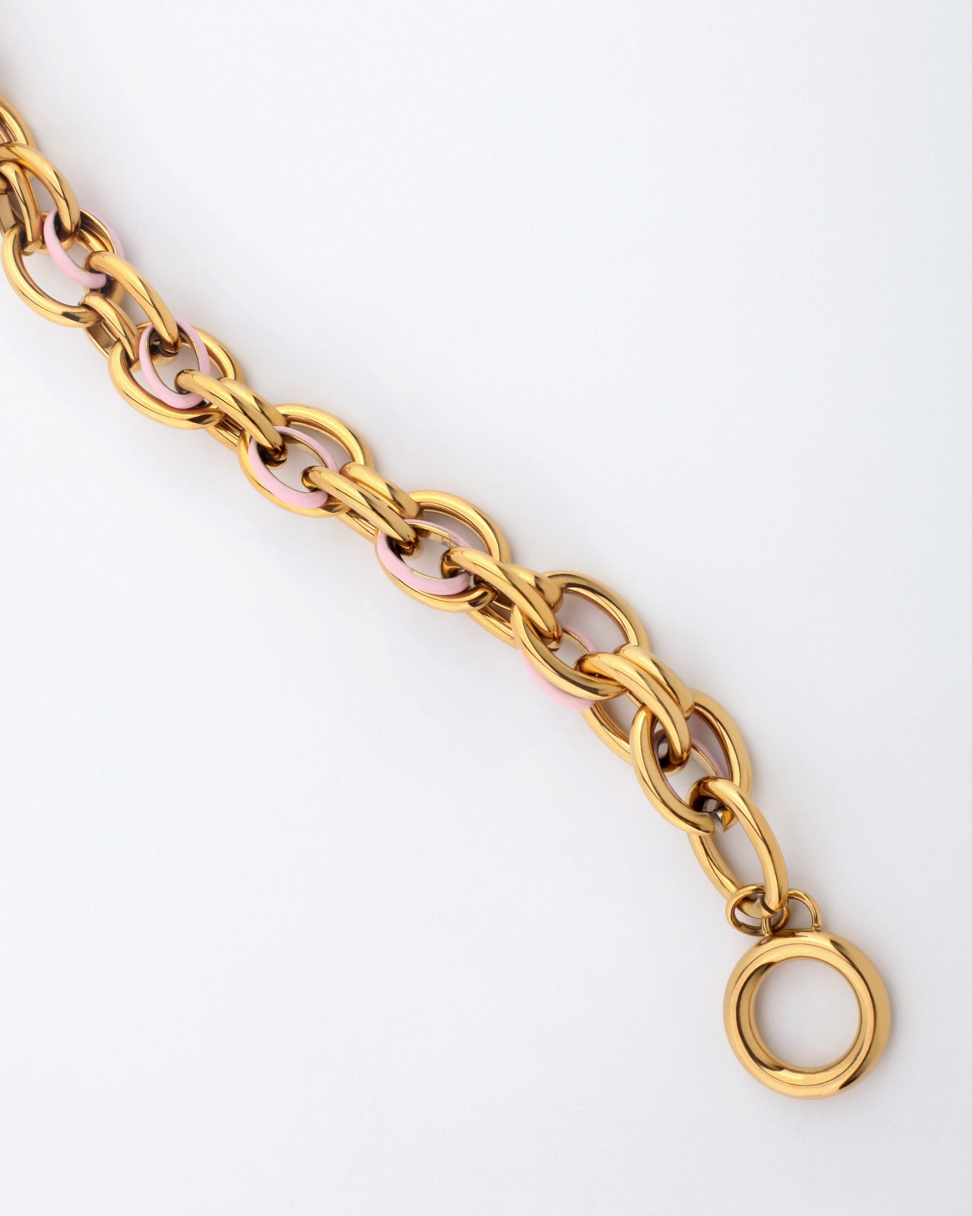 Introducing the Raya Bracelet by For Art's Sake®: This elegant piece features interlocking links that combine alternating sections of gold and light pink. Designed for a perfect fit with precise measurements, it is complete with a circular clasp, all presented against a plain white background.