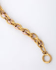 Introducing the Raya Bracelet by For Art's Sake®: This elegant piece features interlocking links that combine alternating sections of gold and light pink. Designed for a perfect fit with precise measurements, it is complete with a circular clasp, all presented against a plain white background.