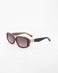 A pair of stylish Bolt sunglasses by For Art's Sake® featuring a handmade acetate frame in thick brown and dark gradient, shatter-resistant nylon lenses. The black temple arms have eye-catching gold-plated chain-link detailing near the hinges. The Bolt sunglasses rest elegantly on a white background.