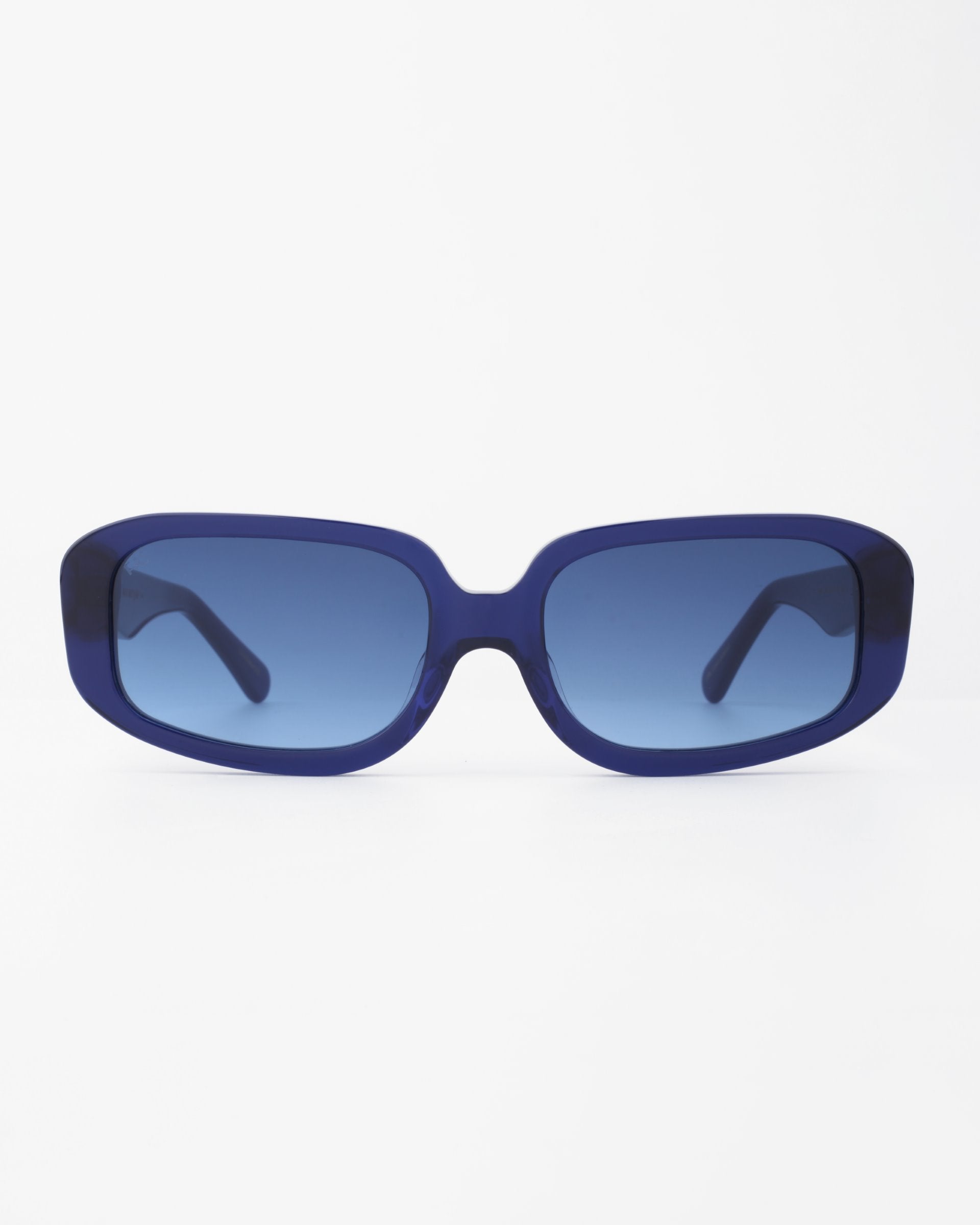A pair of For Art's Sake® Bolt rectangular sunglasses with dark blue handmade acetate frames and blue-tinted, shatter-resistant nylon lenses, displayed against a white background.