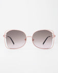 A pair of handmade, large, square-shaped Carousel sunglasses by For Art's Sake® with a thin, pink metal frame and gradient dark to light lenses. Crafted with gold-plated stainless steel for durability and style, they offer full UVA & UVB protection. The glasses are displayed against a plain white background with the temples extended outward.