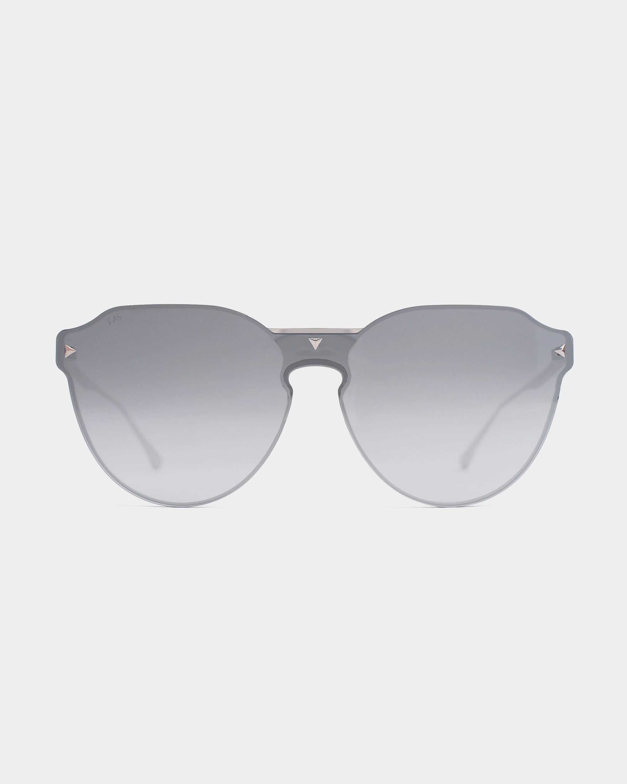 A pair of stylish, frameless Error 404 sunglasses from For Art&#39;s Sake® with large, circular, gradient gray Nylon lenses and a thin metal bridge. The temples, adorned with 18-karat gold plating, are designed in a light-colored metal, offering a sleek and modern appearance against a white background.