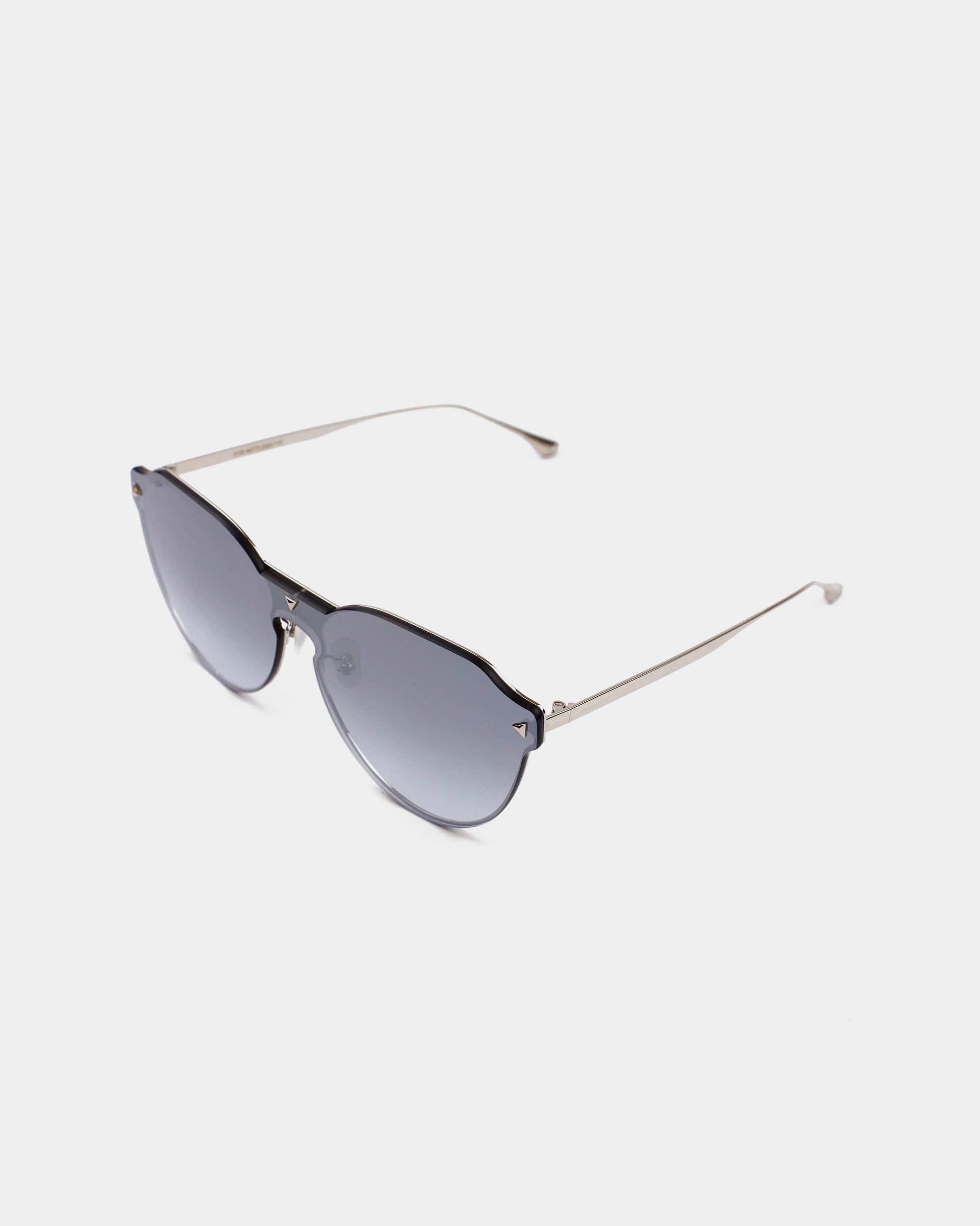 A pair of stylish For Art&#39;s Sake® Error 404 sunglasses with dark tinted hexagonal nylon lenses and thin metal arms. The frame around the lenses is minimalistic, with two small silver accents near the top corners and features UV protection. The background is plain white.