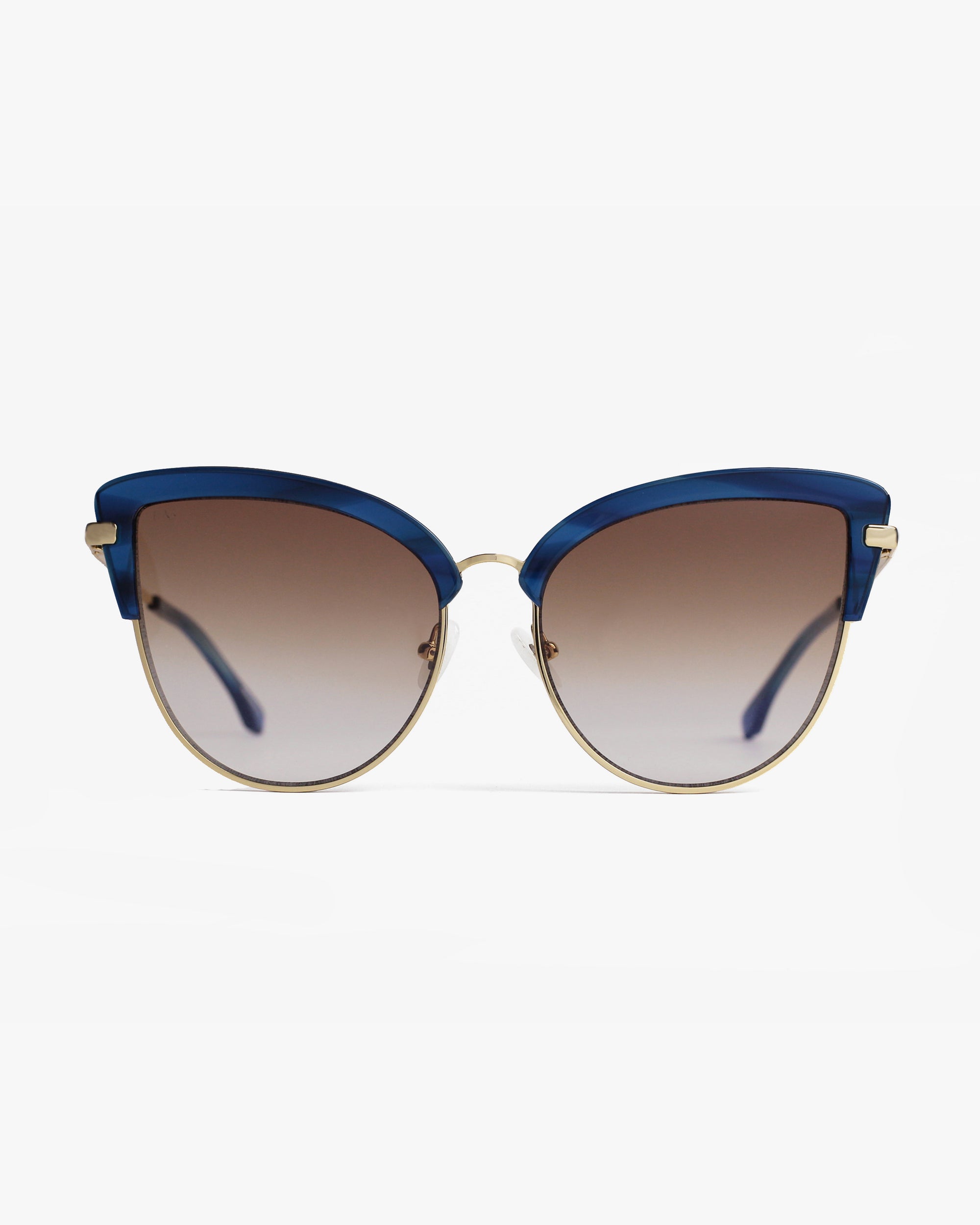A pair of stylish cat-eye Venus sunglasses by For Art&#39;s Sake® with 18-karat gold plated frames and blue accents along the top. The nylon lenses are gradient, transitioning from dark at the top to lighter at the bottom. The sunglasses are placed against a plain white background.
