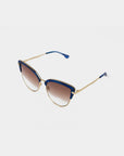 A pair of stylish Venus sunglasses by For Art's Sake® featuring stainless steel frames with 18-karat gold plating, blue accents along the top edge, and gradient brown nylon lenses. The temple arms are gold with blue tips, giving the eyewear a fashionable and elegant look.