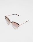 A pair of stylish For Art's Sake® Venus sunglasses with thin, 18-karat gold-plated frames and gradient nylon lenses transitioning from a darker top to a lighter bottom. The top part of the frames has a tortoiseshell pattern. The For Art's Sake® Venus sunglasses are placed against a plain white background.
