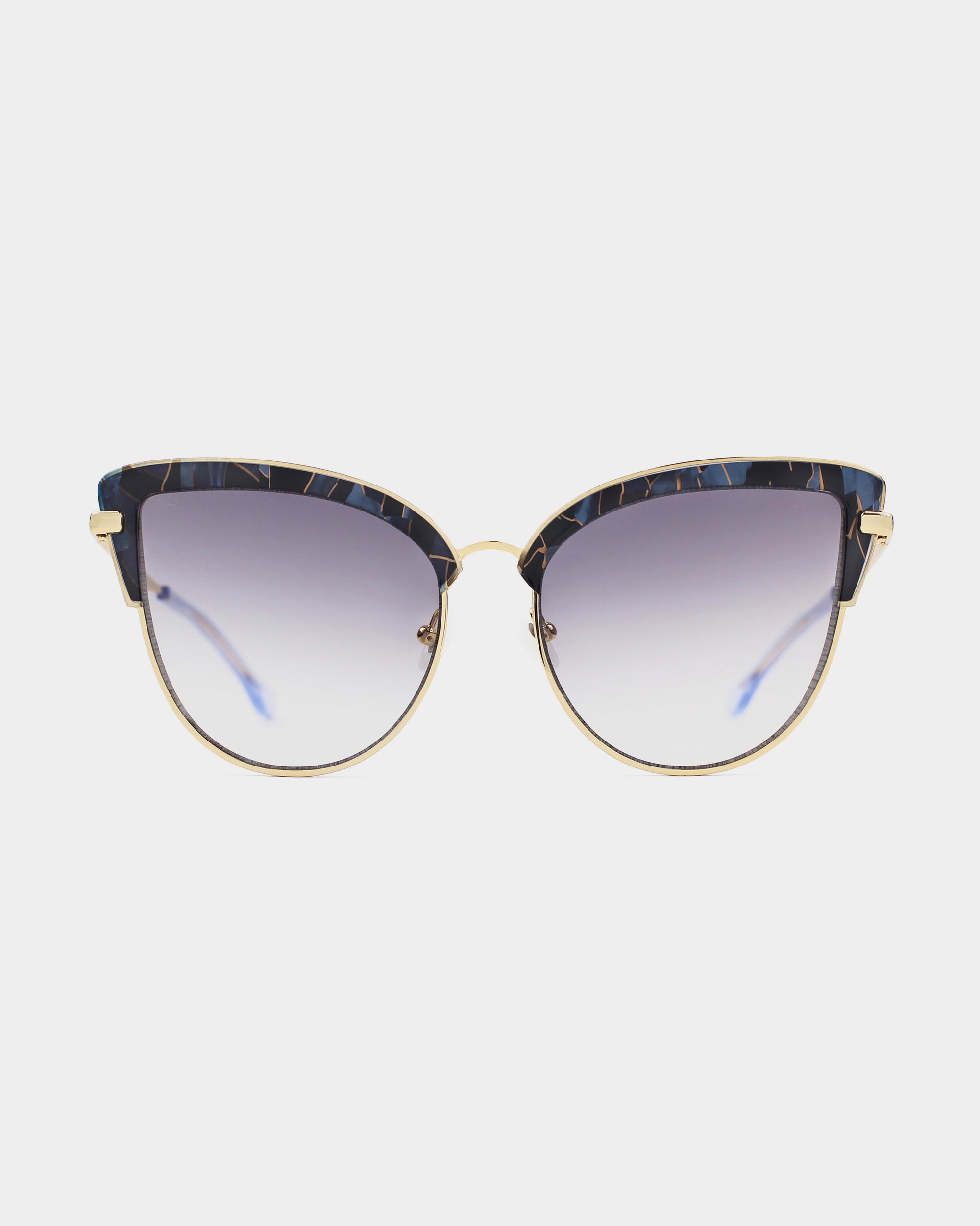 A pair of oversized cat-eye sunglasses with gradient lenses and a sleek design. The stainless steel frames are gold with dark, speckled top rims. The temples are thin and also gold, providing 100% UV protection and giving the Venus sunglasses by For Art's Sake® a stylish and sophisticated look.