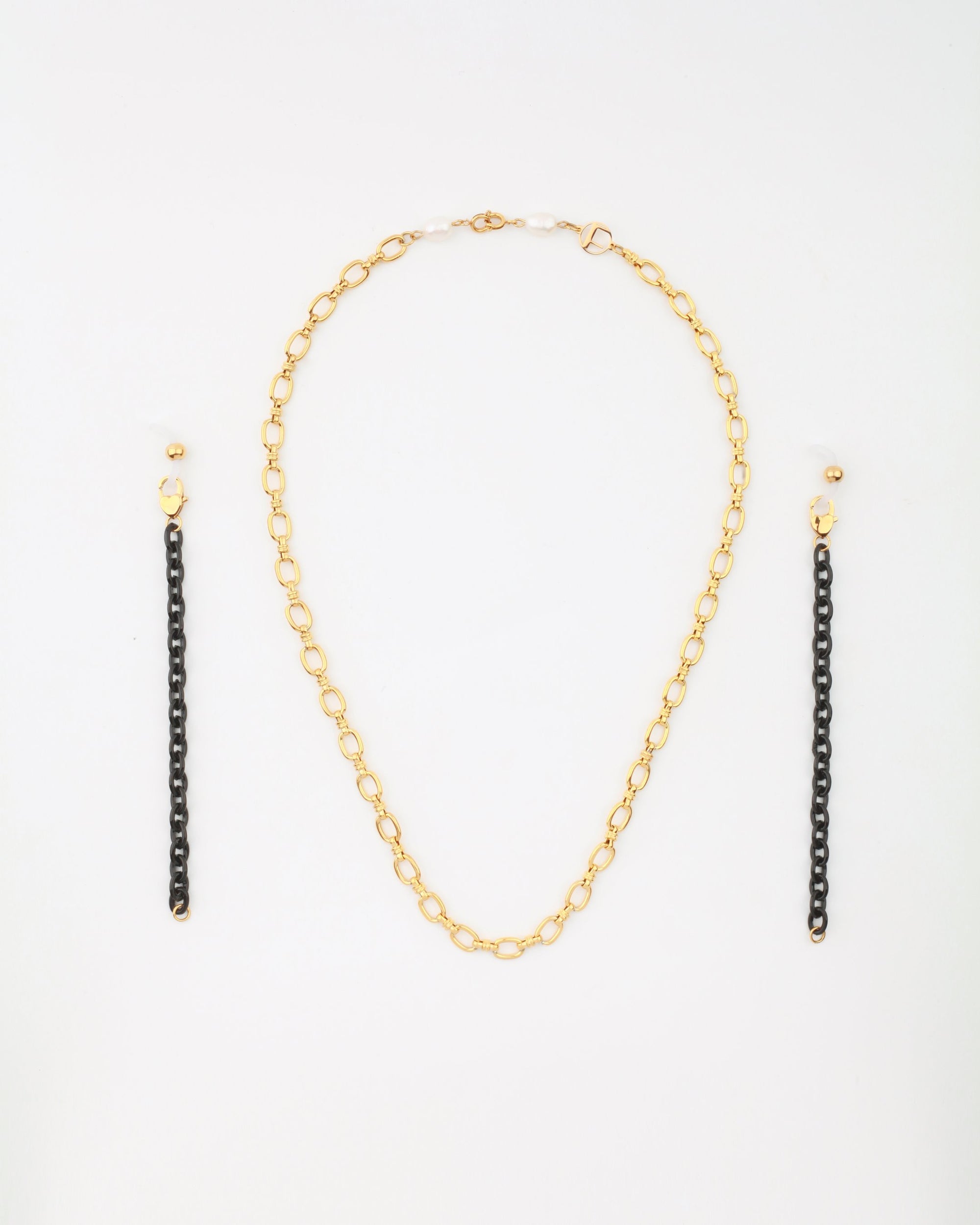 A Tokyo Glasses Chain with medium-sized oval links, 18-karat gold-plated, is centered between two matching earrings. Each earring has a small gold stud and a longer hanging section made of linked black segments. The jewelry is arranged on a plain white background. This stylish piece is from For Art's Sake®.