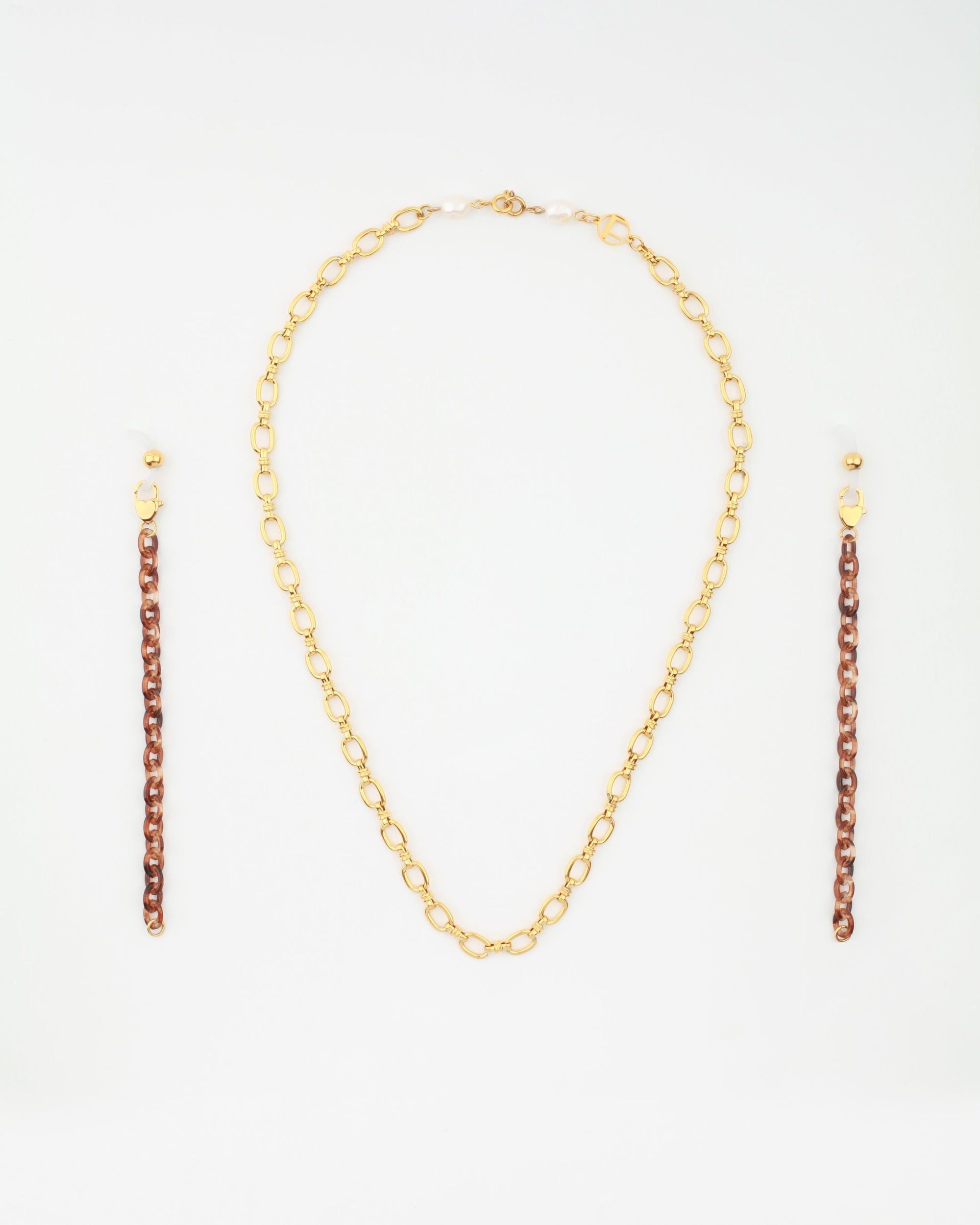 A Tokyo Glasses Chain by For Art's Sake® is centered on a white background. Flanking the chain on both sides are two matching pairs of earrings, each featuring a brown chain link section and ending with small gold and freshwater pearl embellishments.