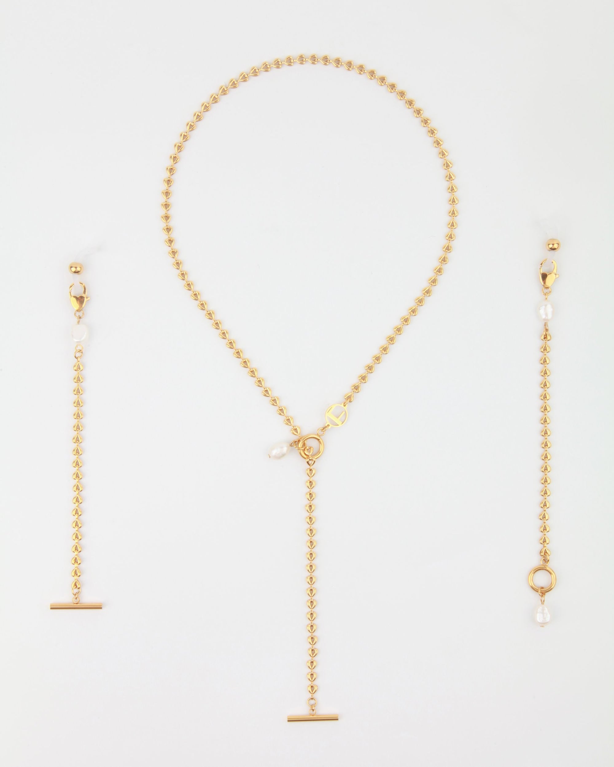 A For Art's Sake® Havana Glasses Chain set against a plain background. The chain features a beaded pattern with freshwater pearl charms and an 18-karat gold-plated bar charm, while the earrings have a long, delicate design with similar pearl and bar accents.