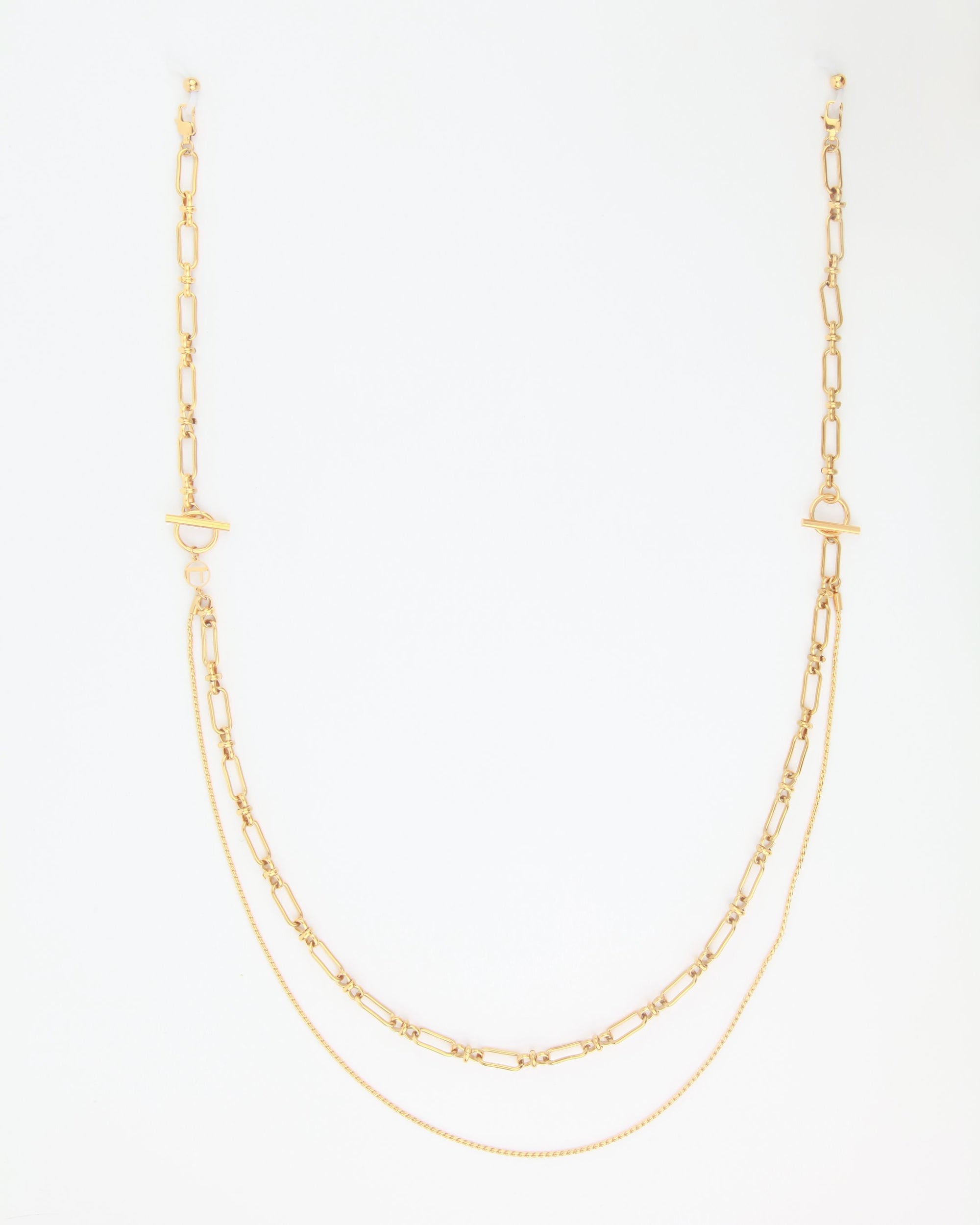 A delicate Vienna Glasses Chain is displayed against a plain white background. The 18-karat gold-plated piece by For Art&#39;s Sake® features two types of chains: one with elongated oval links and the other a smooth, fine chain, creating a layered effect. The clasp is a T-bar style.