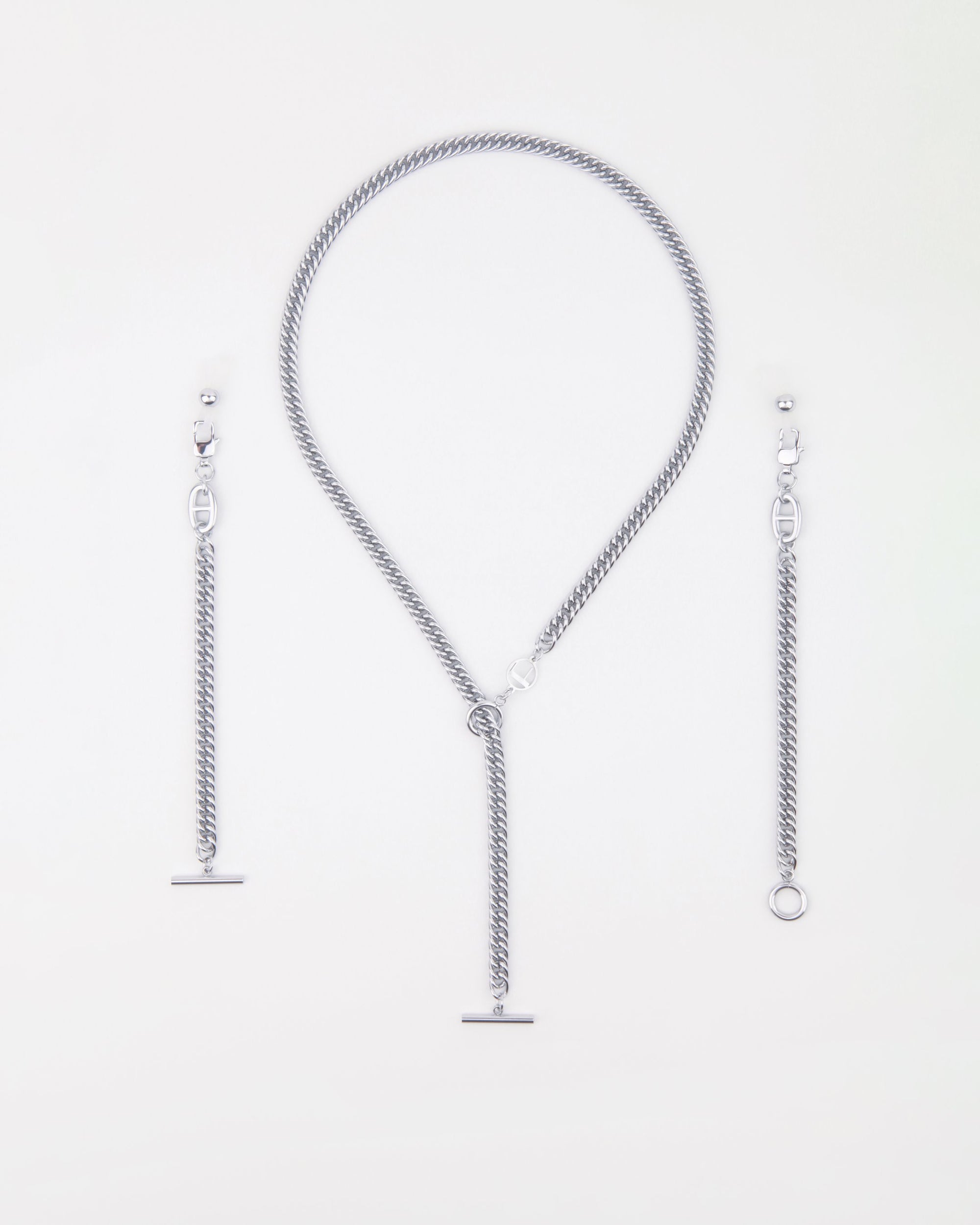 A silver-toned twisted chain statement necklace with a toggle clasp and two matching chain bracelet extensions or add-ons. The Lisbon by For Art's Sake® is displayed in a circular shape, and the bracelet extensions are positioned on either side. The background is plain white.