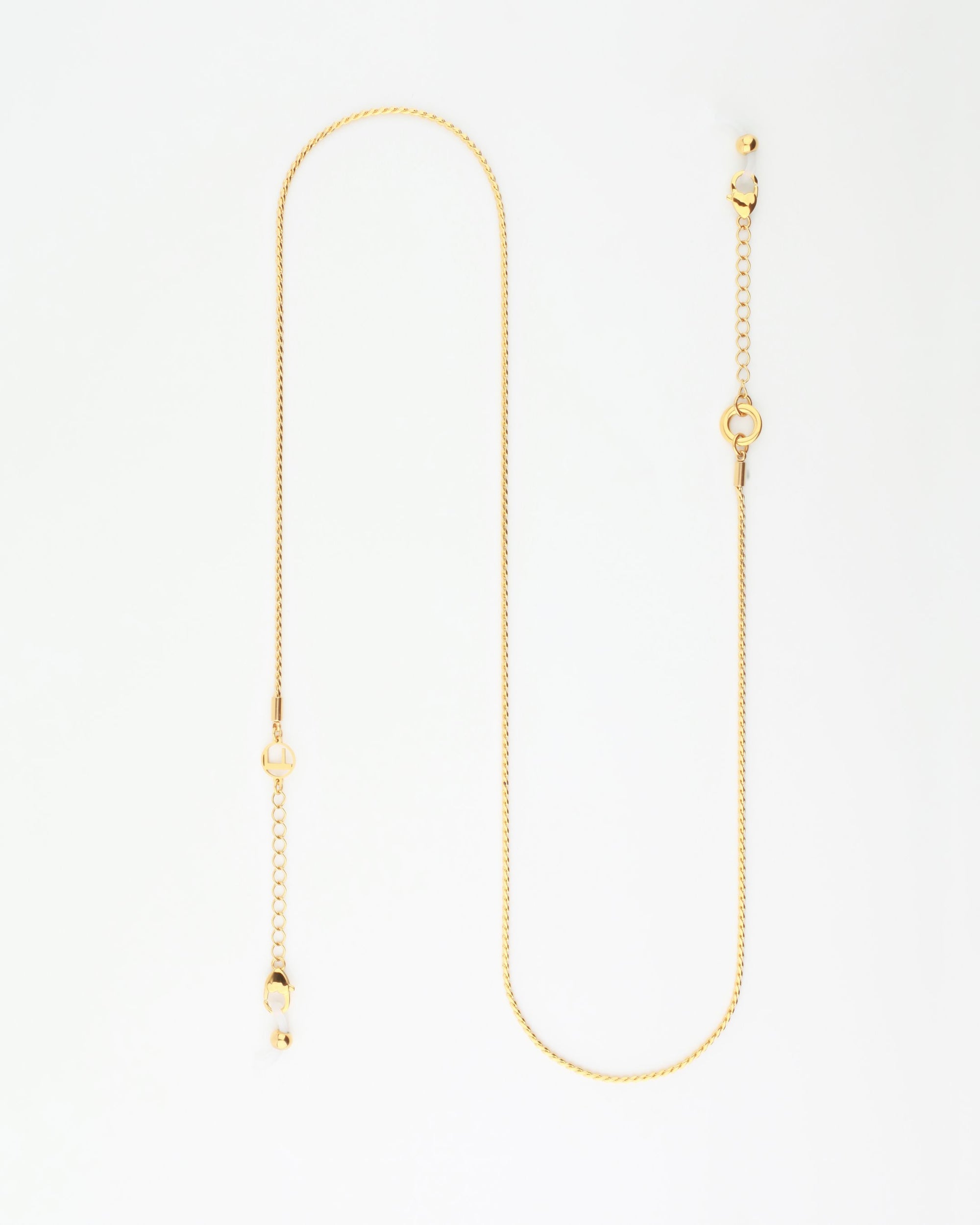 A delicate Miami Glasses Chain with a simple design, featuring small loops and a few discreet links throughout. Crafted by For Art's Sake® with 18-karat gold-plating, the chain ends in a standard clasp and a short extension chain for adjustable lengths. The background is a plain white surface.