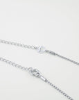 Close-up of two silver necklaces lying parallel against a light background. Each necklace has a thin wheat chain with different styled clasp mechanisms and additional chain link closures for adjustable lengths. The upper necklace features a circular clasp with an "F" inside, part of the Miami Glasses Chain by For Art's Sake®.