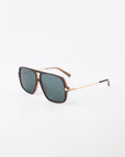 A pair of stylish For Art's Sake® Cinnamon sunglasses featuring a brown square frame with 18-karat gold-plated metal arms and dark tinted lenses. The sunglasses have a chic, modern design with a minimalist aesthetic. The background is plain white.