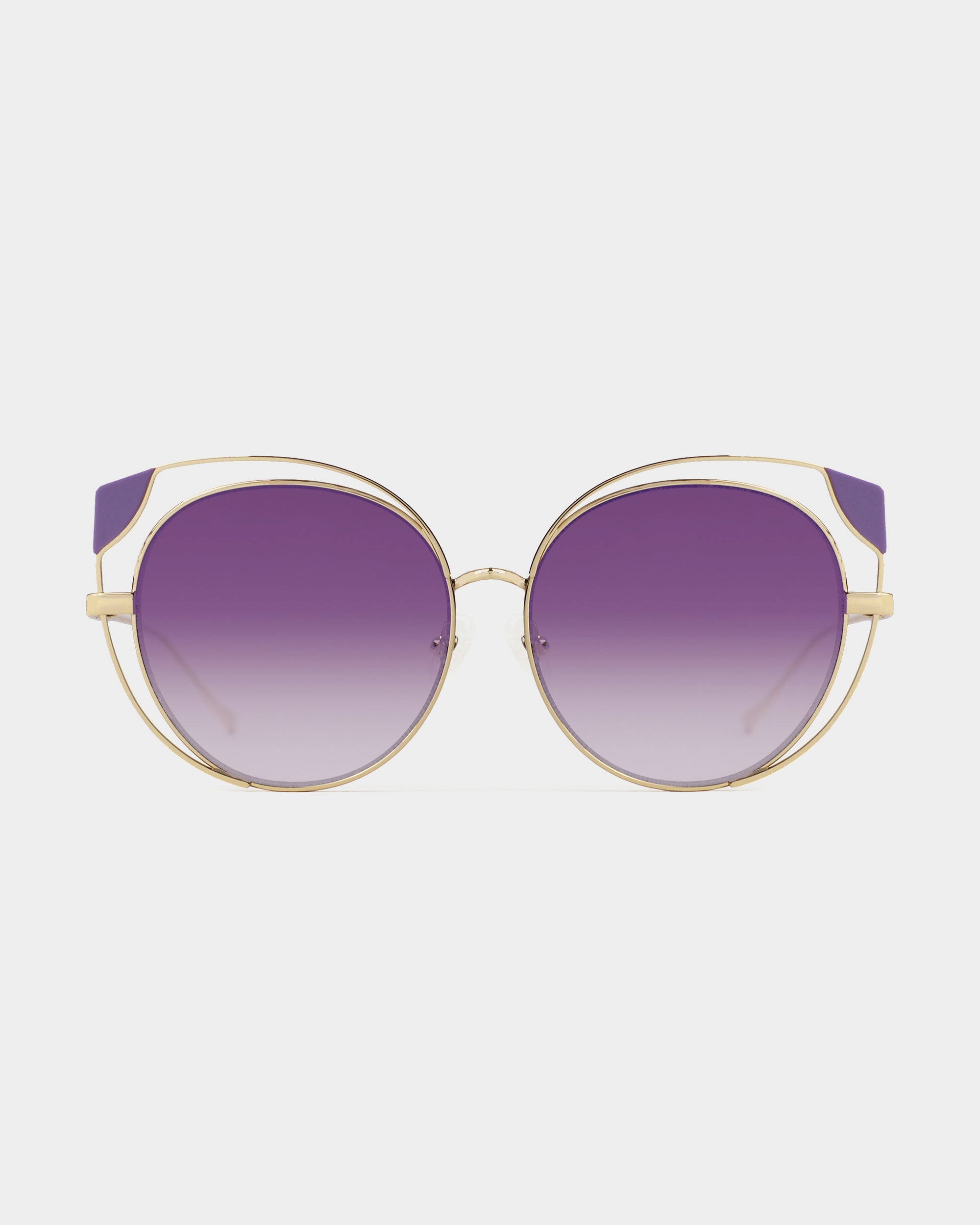 Introducing Skylar by For Art's Sake®: a pair of stylish sunglasses with round, gradient purple lenses and a gold metal frame. The design features a double bridge and sleek arms, giving it a modern and chic look against a white background. Don't miss your Last Chance to buy these stunning accessories!