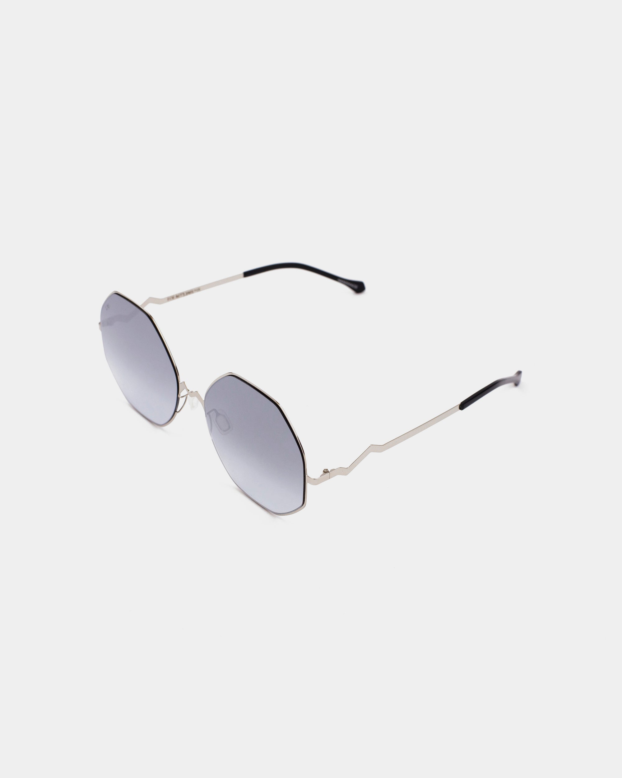 A pair of For Art&#39;s Sake® M8 sunglasses featuring dark-tinted octagonal amber lenses and thin stainless steel frames with curved temples ending in black plastic tips, set against a plain white background.