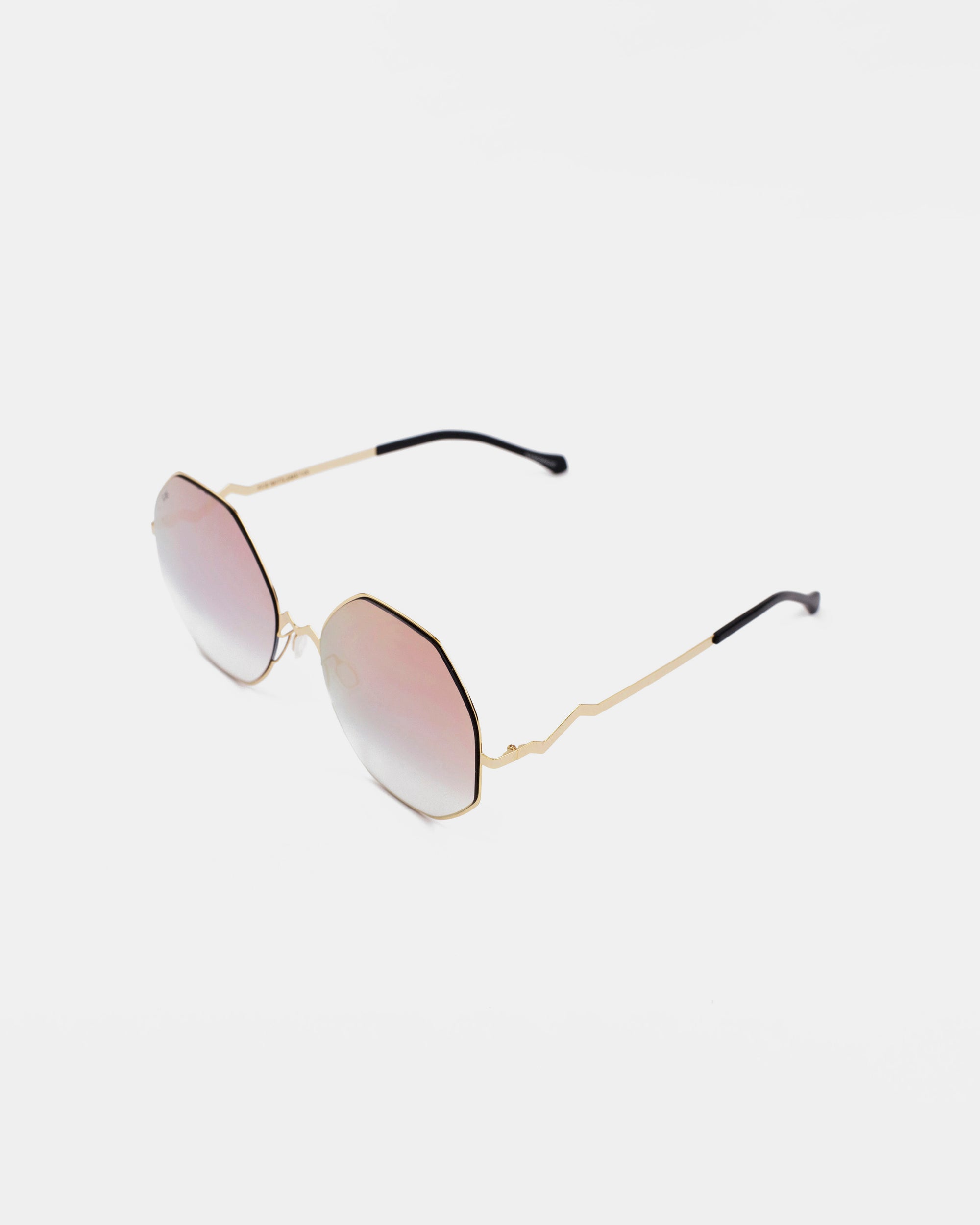 A pair of stylish M8 sunglasses from For Art&#39;s Sake® featuring thin gold frames and octagonal lenses with a gradient tint, transitioning from light pink to a subtle reflective surface. The gold temples have a slight zigzag design and black tips, providing UV protection and sleek sophistication against a white background.