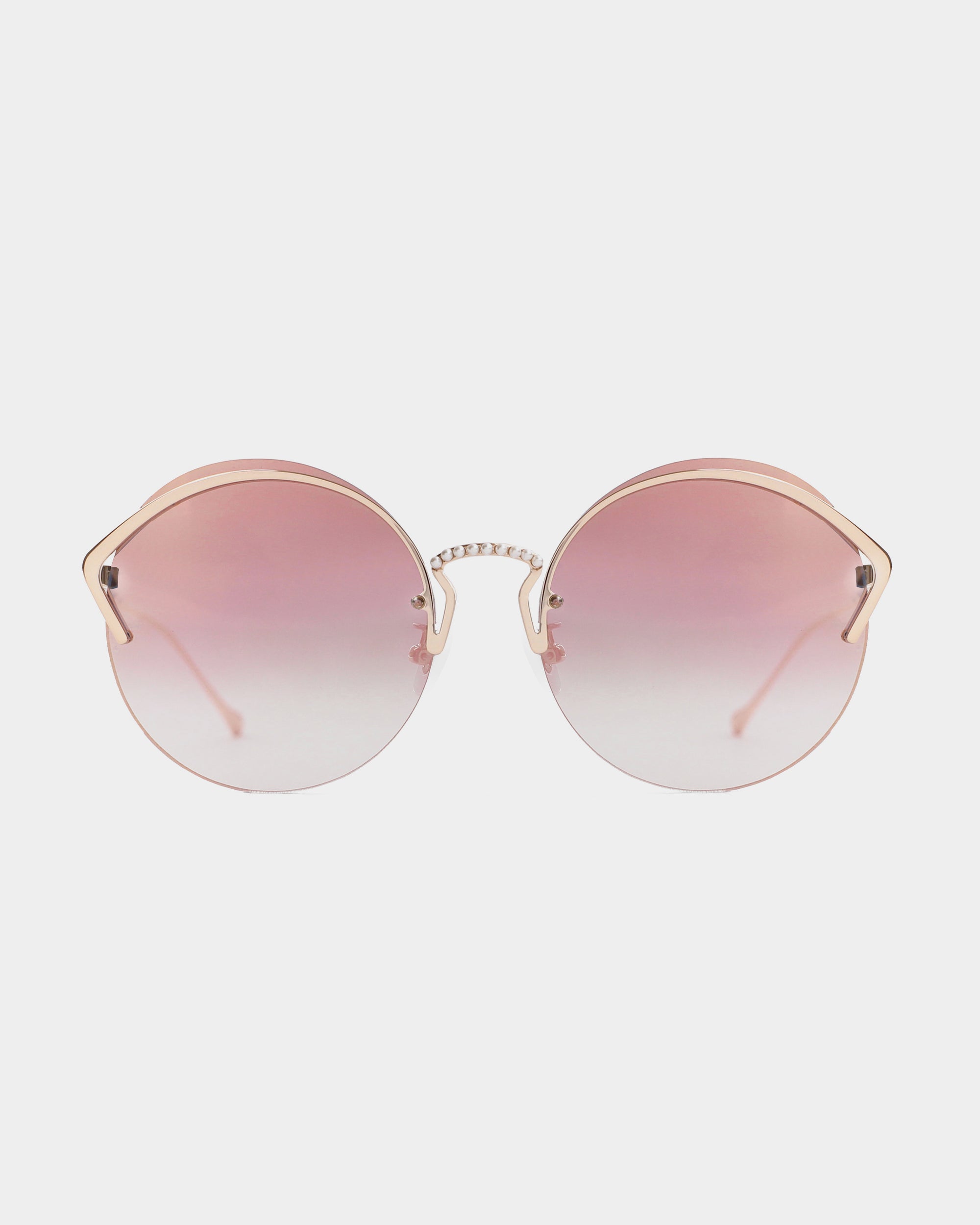 A pair of stylish, round, pink-tinted sunglasses with a gold frame is centered against a plain white background. The lenses have a gradient effect, fading from dark pink at the top to lighter pink at the bottom. These chic For Art's Sake® Margarita shades offer UV protection for your eyes all day long.