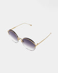 A pair of stylish round sunglasses with gradient nylon lenses and thin gold, stainless steel frames. The glasses are set against a plain white background, showcasing their elegant design, UV protection, and slim metal temples with small end tips. These are the Margarita sunglasses by For Art's Sake®.