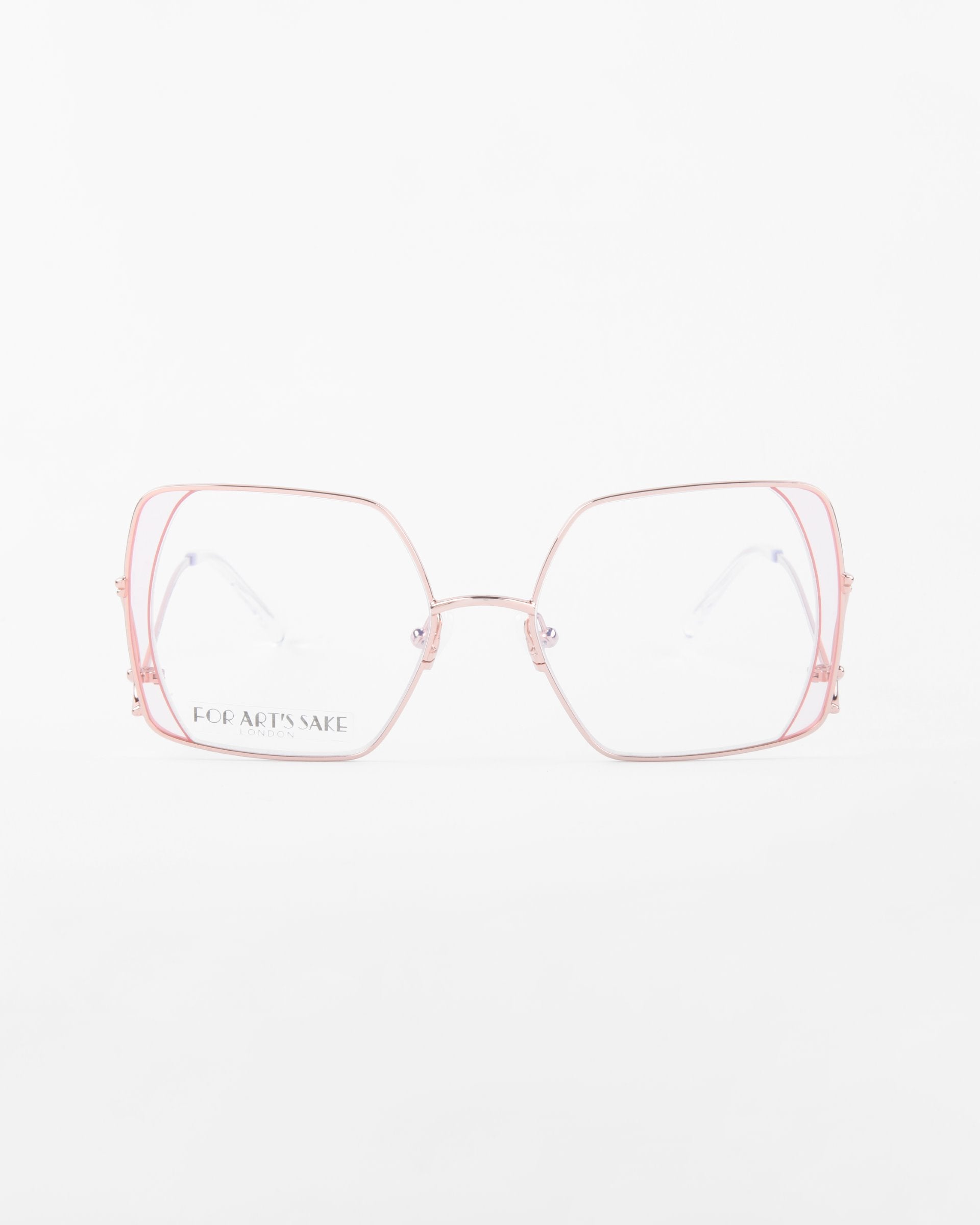 A pair of oversized eyeglasses featuring square-shaped lenses with a double frame design. The outer frame is made of thin, pink stainless steel, creating a modern and stylish look. The clear lenses are centered, and the background is plain white. These eyeglasses are called Candy by For Art&#39;s Sake®.