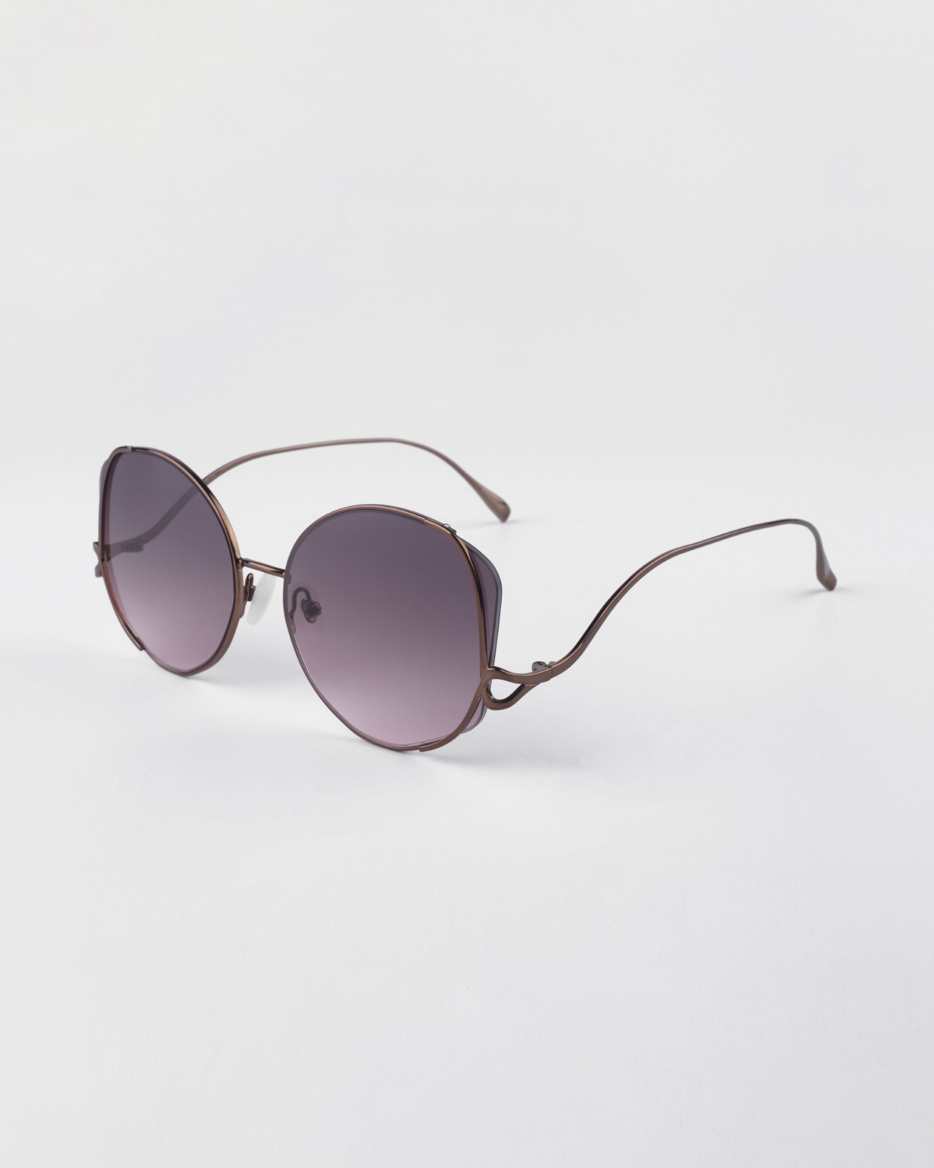 For Art&#39;s Sake Canvas sunglasses in Rose. Side view of glasses showing the rose gold metal frames and round shape. 