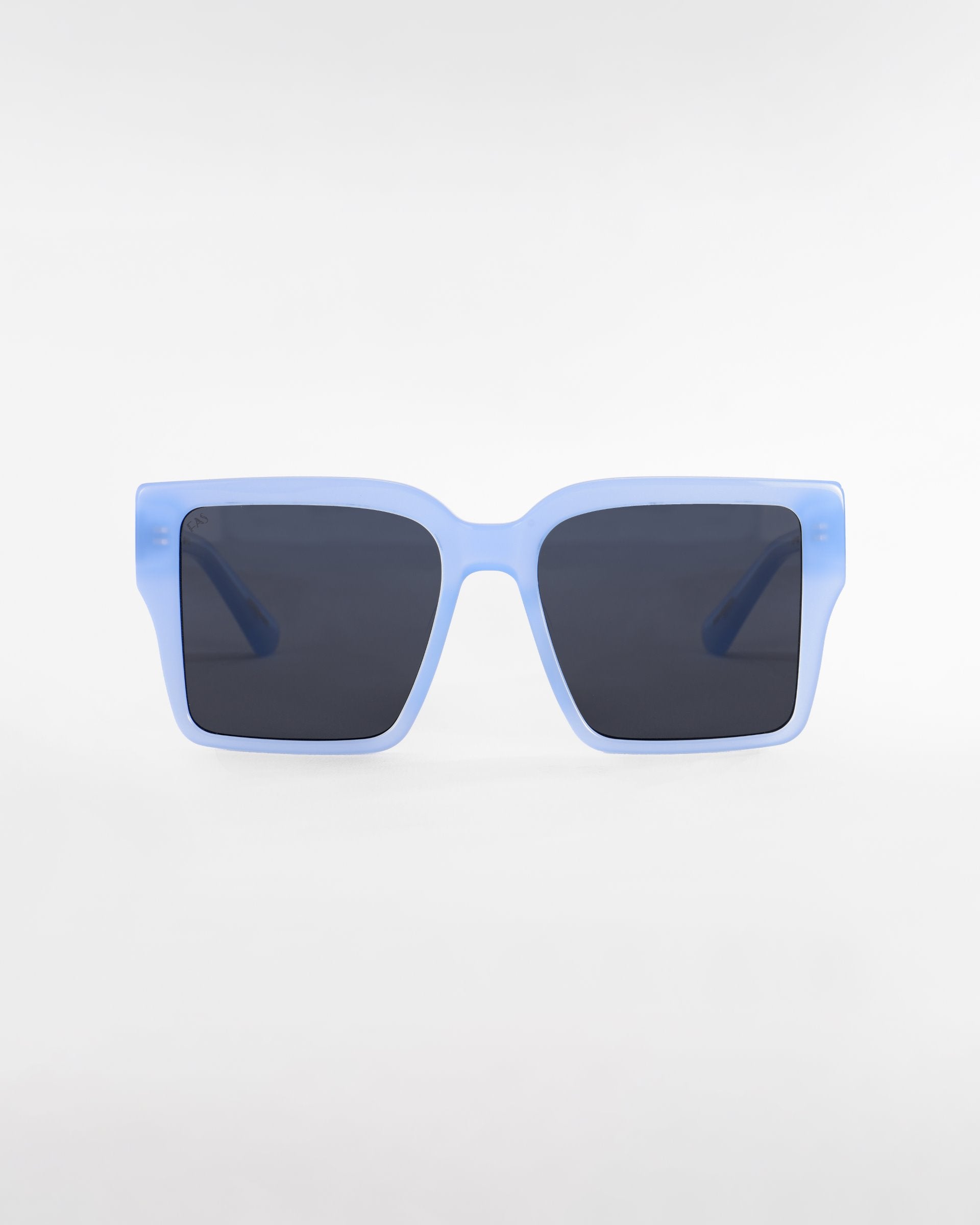 A pair of For Art's Sake® Castle oversized square-shaped sunglasses with light blue frames and ultra-lightweight dark lenses, centered against a plain white background.