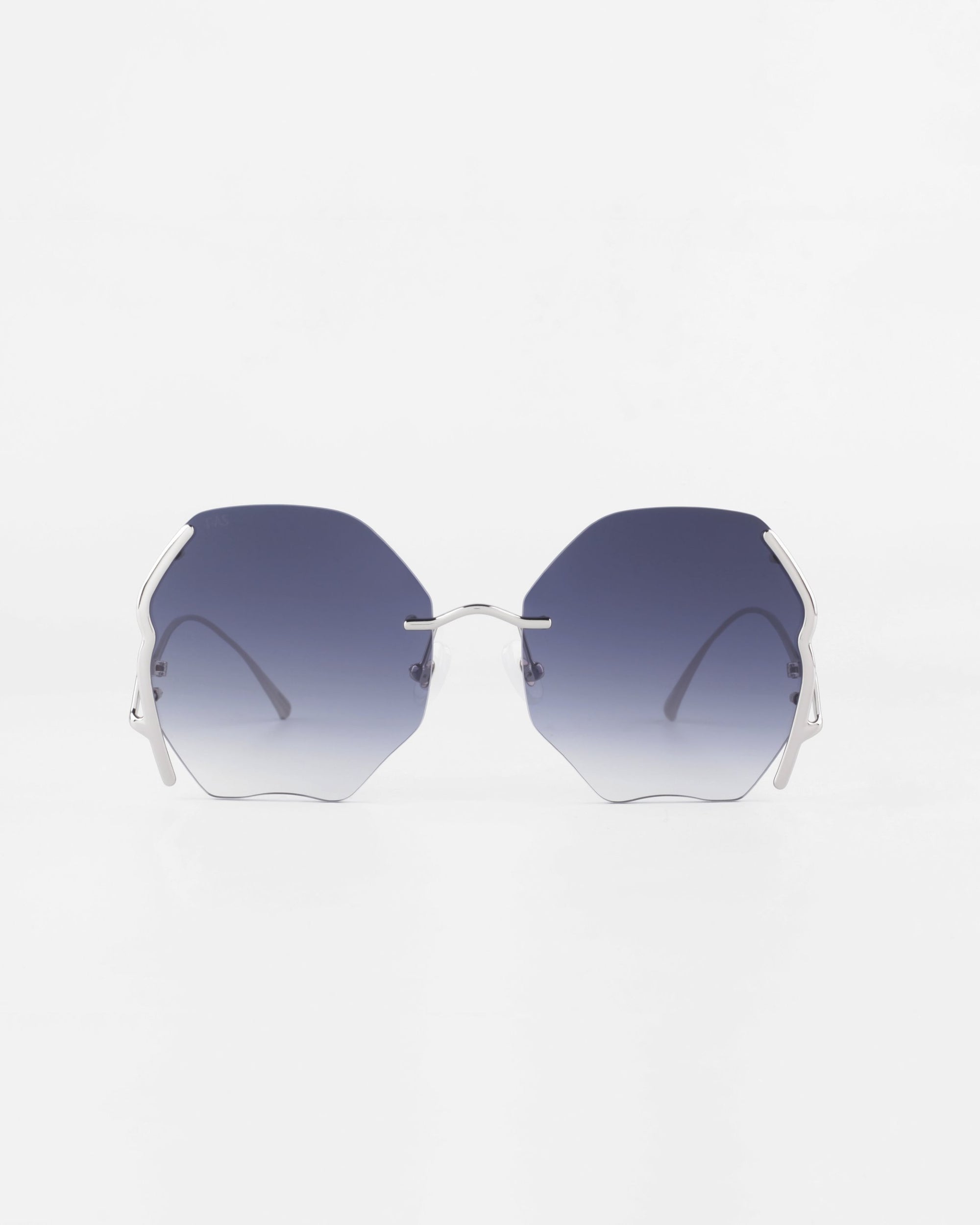 A pair of Century sunglasses from For Art's Sake® with gold-plated stainless steel thin frames. The ultra-lightweight nylon lenses offer 100% UVA & UVB protection and have a gradient from dark blue at the top to clear at the bottom. The Century sunglasses are displayed against a plain white background.