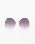 A pair of geometric form Century sunglasses by For Art's Sake® with large, purple gradient, polygon-shaped lenses. The frame is minimalistic and gold-plated stainless steel, featuring delicate temples and no prominent bridge connecting the lenses. With 100% UVA & UVB protection, the plain white background highlights these stylish sunglasses.