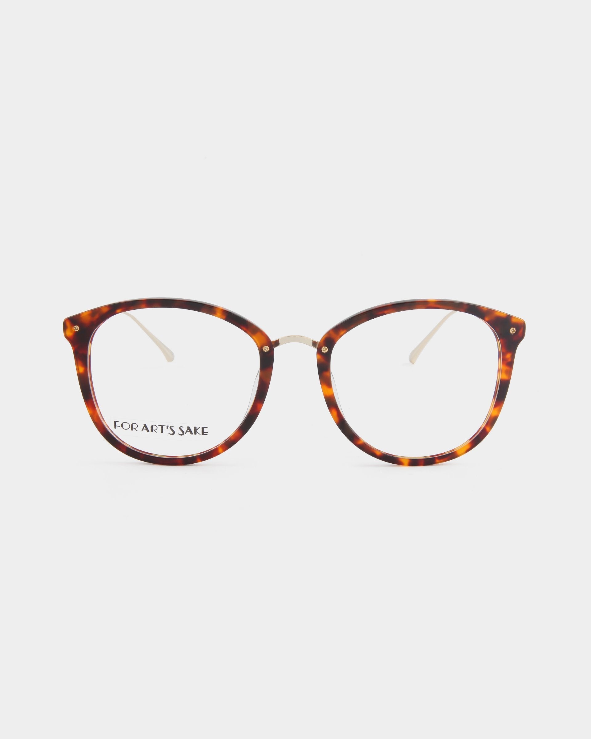 A pair of eyeglasses with round tortoiseshell frames and clear lenses is shown against a white background. The brand's name, "For Art's Sake®," is visible on the inside of the left arm, highlighting their premium opticals which also come with an optional blue light filter for added protection.