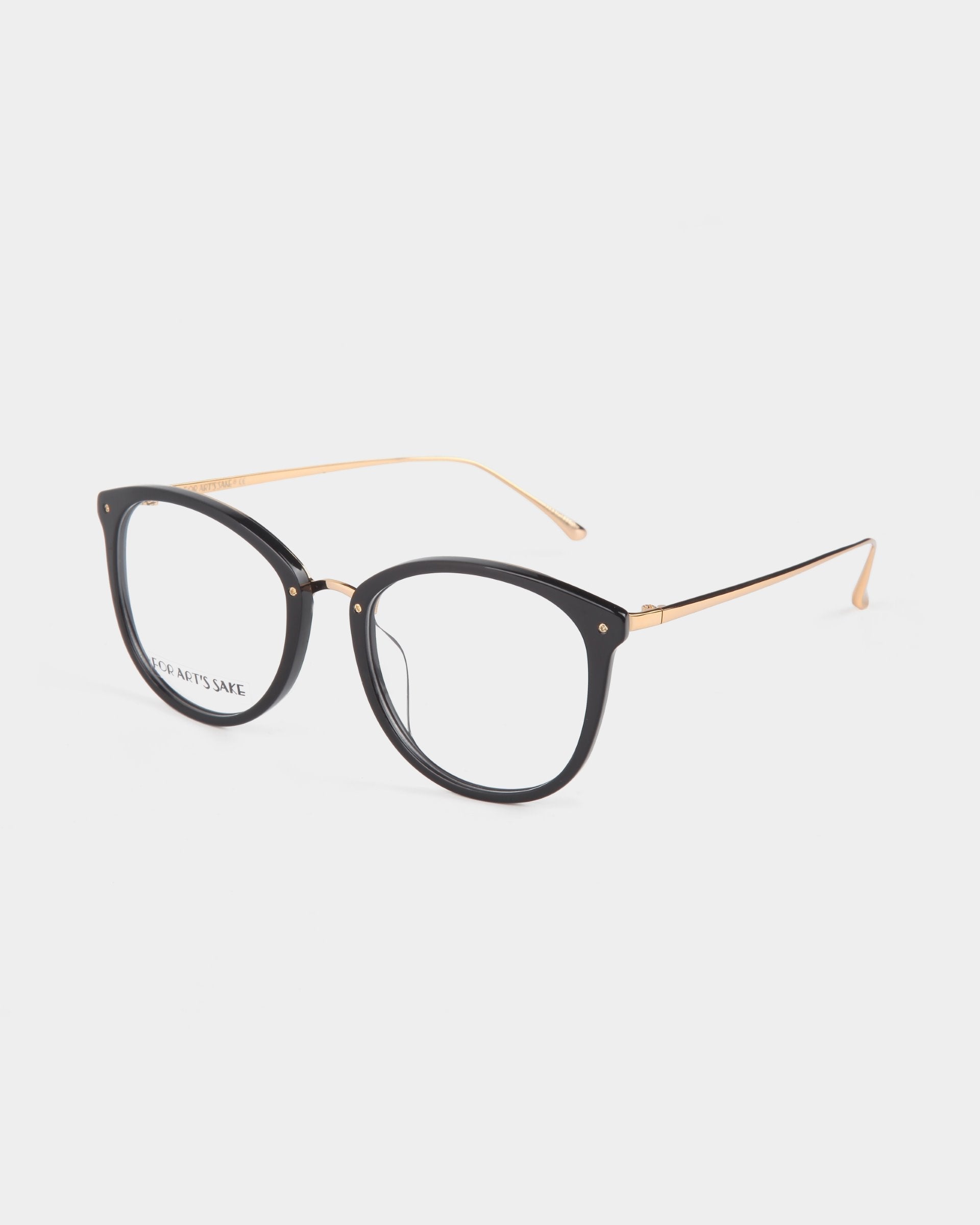 A pair of stylish Club eyeglasses by For Art&#39;s Sake® with black round frames and thin gold temples, featuring the left lens displaying the brand name in small font. These eyeglasses, offering blue light filter technology, are placed against a plain white background.