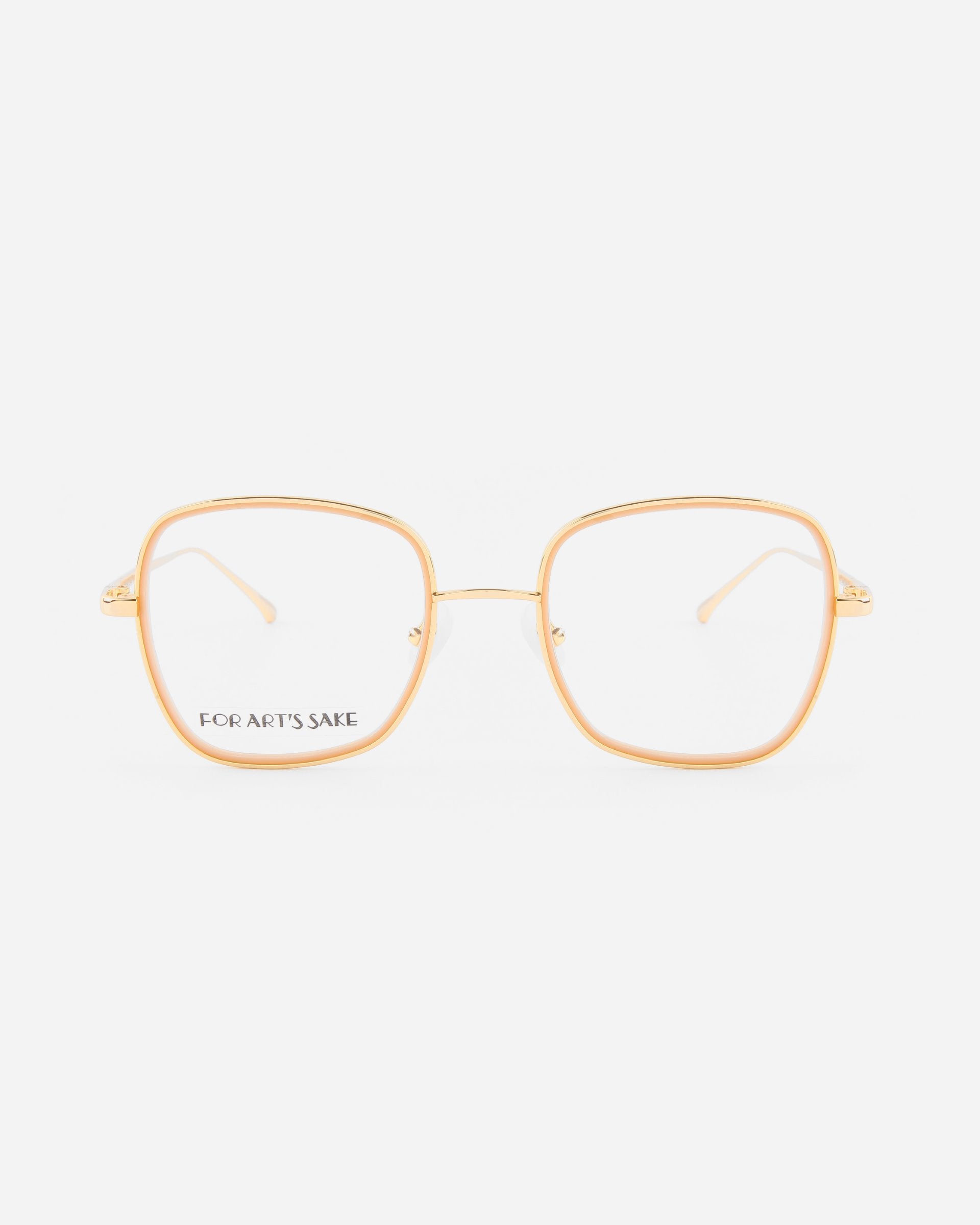 A pair of 18-karat gold-plated eyeglasses with large, slightly rounded square lenses. The frame is thin and elegant, with transparent nose pads. The inside of the left lens is printed with the words "FOR ARTS SAKE." These stylish Coconut eyeglasses by For Art's Sake® also come with a Blue Light Filter for added comfort.