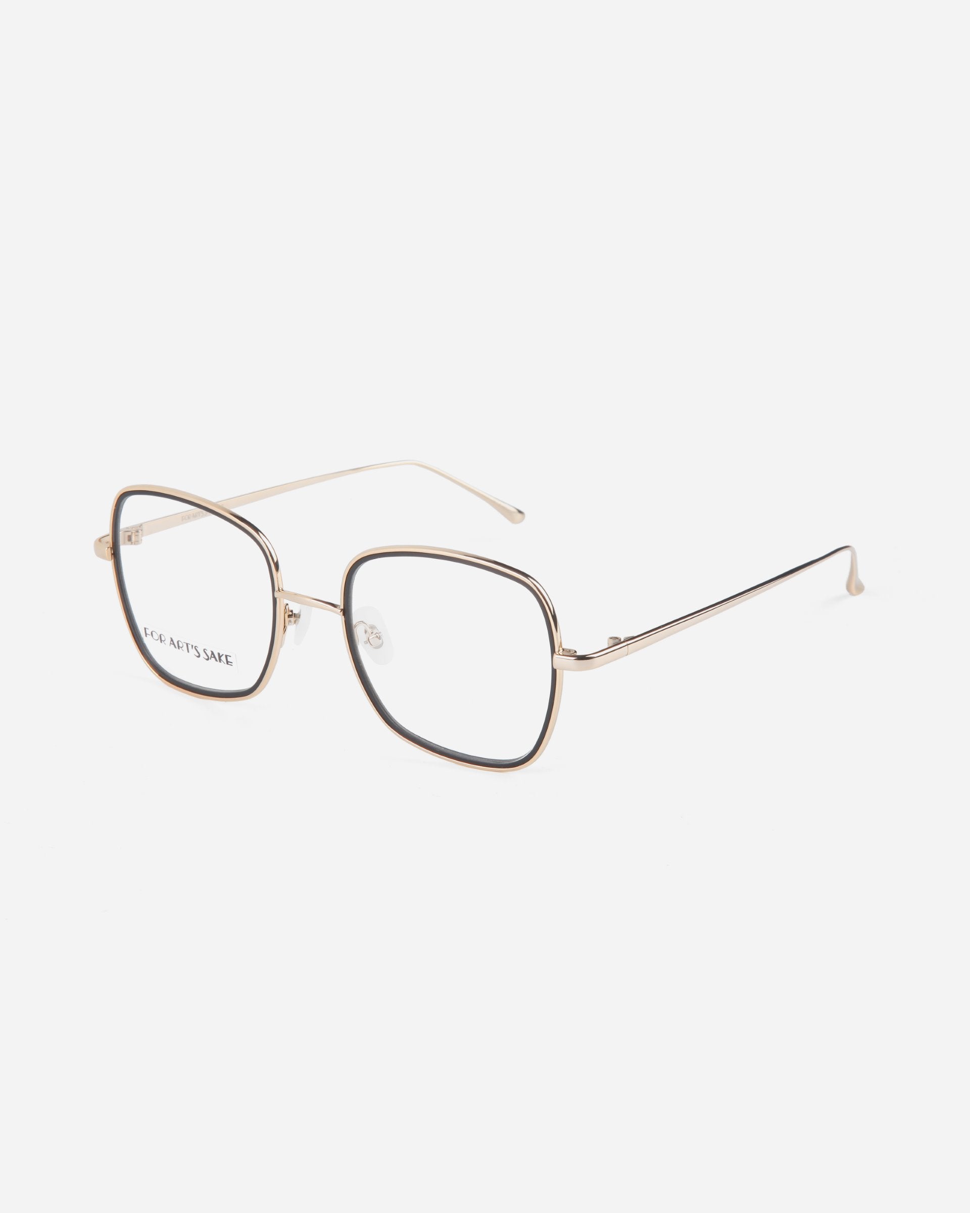 A pair of gold-rimmed, square eyeglasses with thin metal temples, transparent nose pads, and ultra-lightweight lenses featuring a blue light filter. The glasses are set against a plain white background. These are the Coconut by For Art&#39;s Sake®.