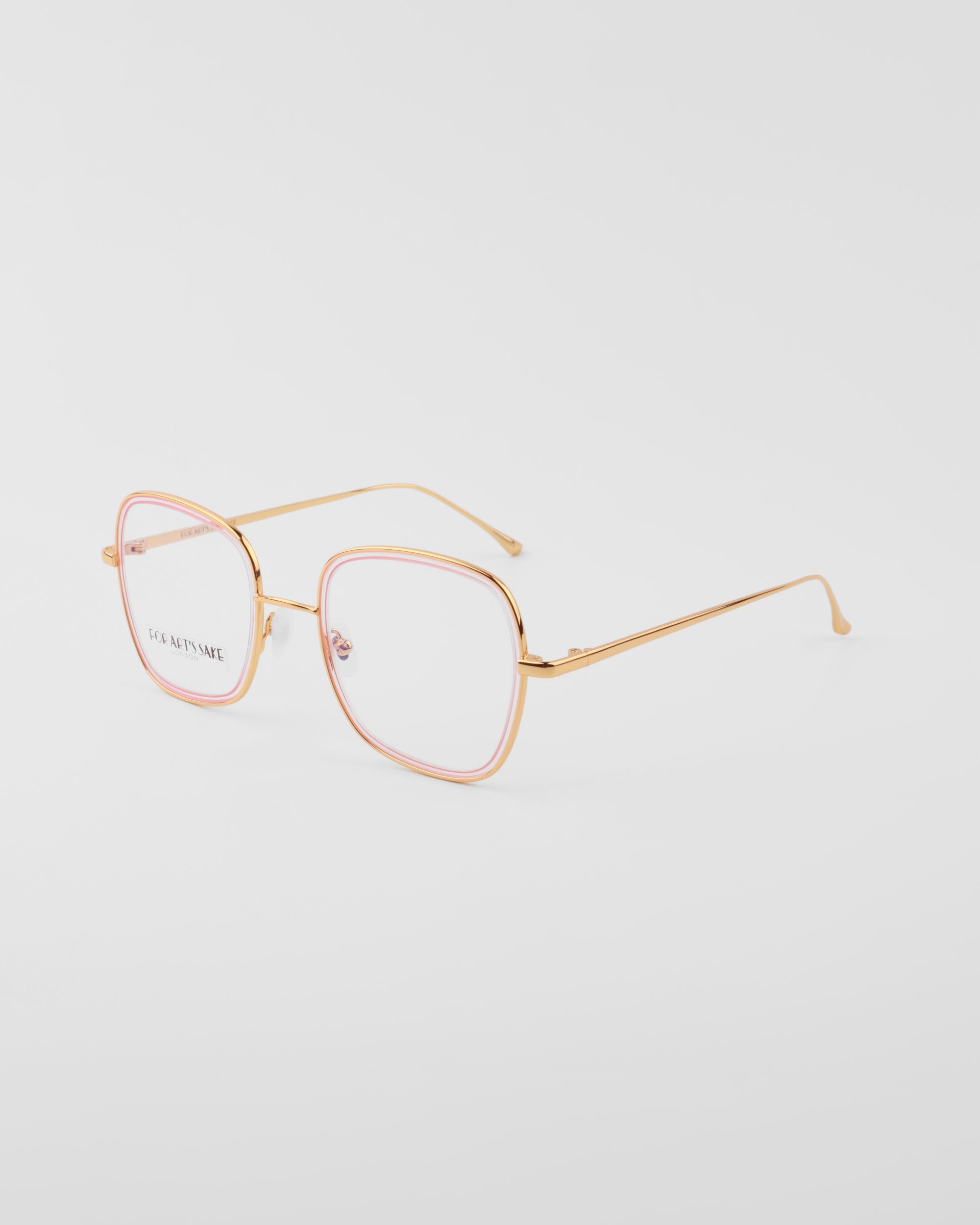 A pair of For Art&#39;s Sake® Coconut eyeglasses with thin, 18-karat gold-plated frames and pink square rims around the clear lenses, photographed on a white background. The nose pads are adjustable for comfort. The slender arms are straight with a slight curve at the ends.