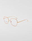 A pair of For Art's Sake® Coconut eyeglasses with thin, 18-karat gold-plated frames and pink square rims around the clear lenses, photographed on a white background. The nose pads are adjustable for comfort. The slender arms are straight with a slight curve at the ends.