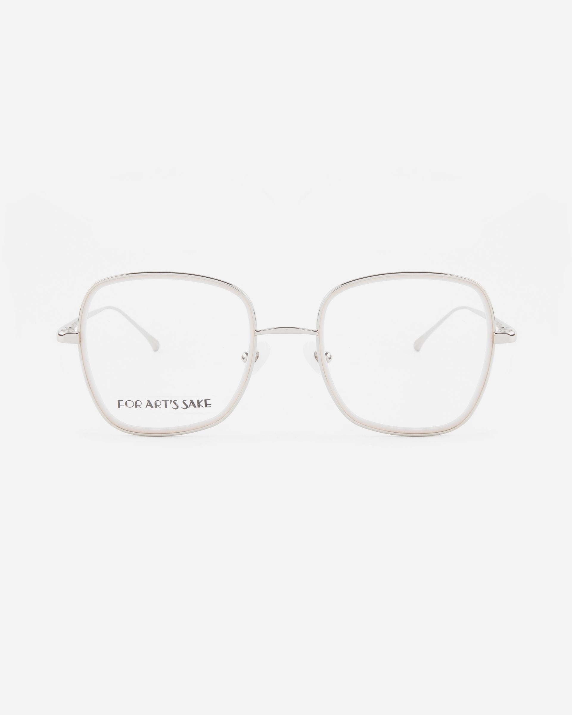A pair of square-shaped, rimless eyeglasses with thin metal temples. The words &quot;For Art&#39;s Sake®&quot; are printed in small black capital letters on the left lens. These stylish frames, named *Coconut*, are enhanced with 18-karat gold-plated details, set against a plain white background.