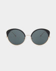 A pair of stylish Cocoon by For Art's Sake® sunglasses with black frames and dark tinted lenses, set against a plain white background. The temples are thin and metallic, adding to the sleek and modern design. This handcrafted eyewear also offers UV protection, ensuring both elegance and safety.